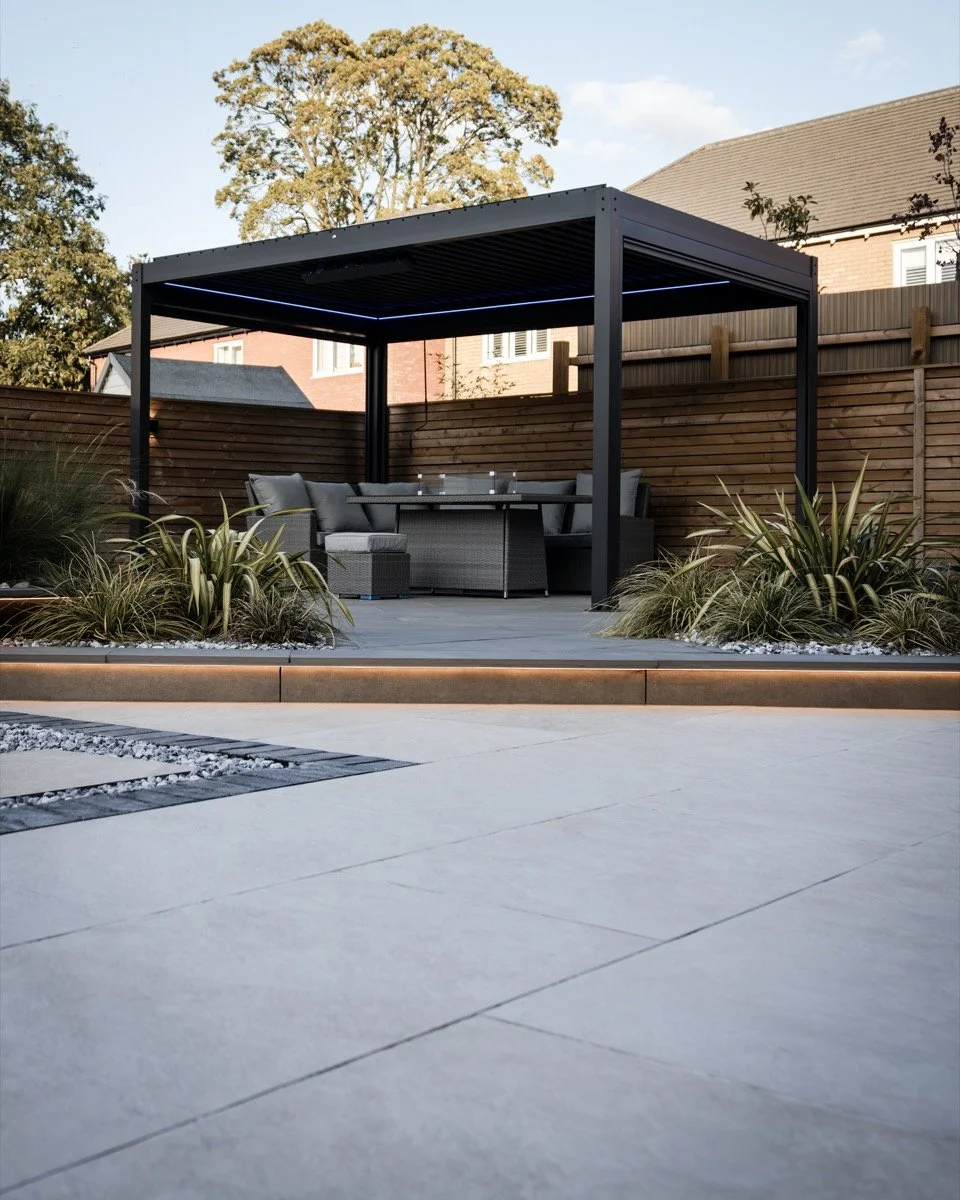 Modern outdoor living area featuring stylish pergola, landscaped patio and carefully designed planting.