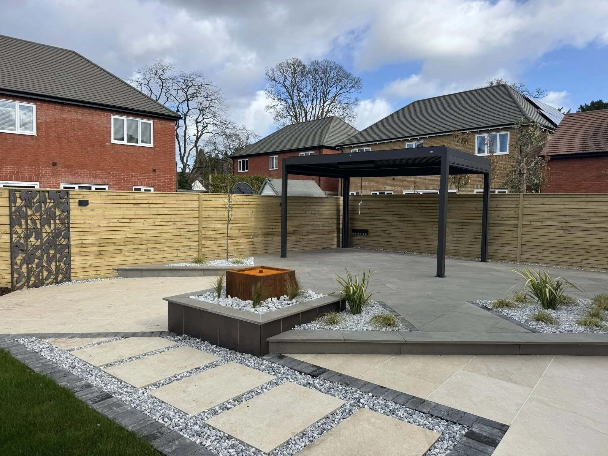 Porcelain patio installation in Staffordshire with modern paving and landscaped garden