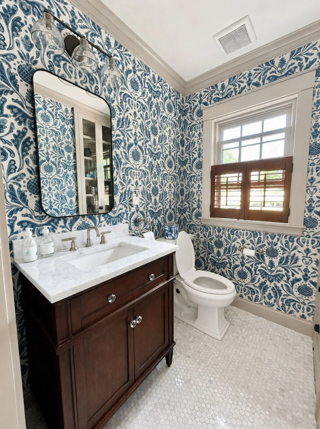This half bath was part of a full home renovation we completed on the north shore. Classic &amp; timeless design is appropriate for the antique home while still offering modern ambiance. 

*this is an actual photo of our work, AI was used to make our