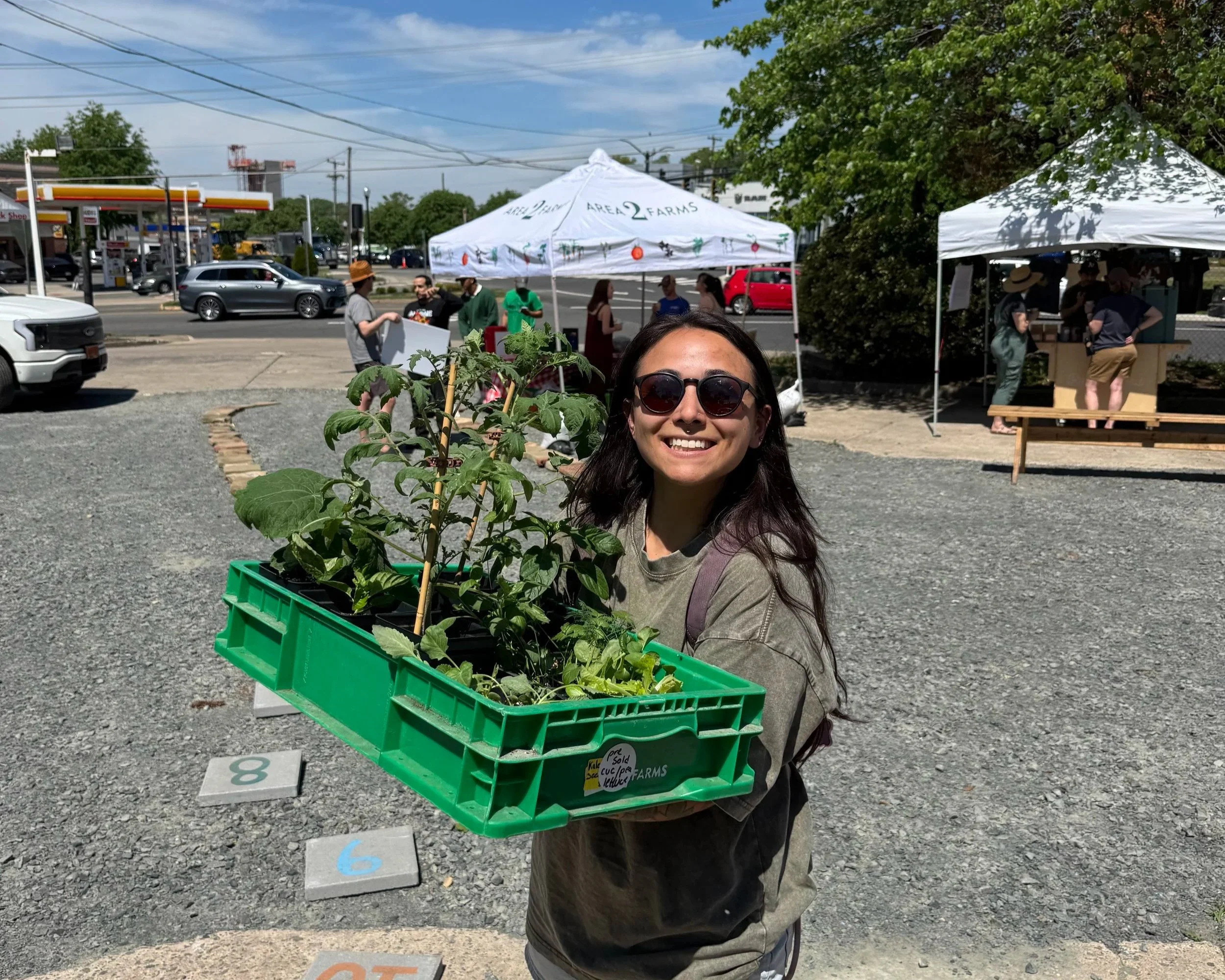 Area 2 Farms' community member with organic seedlings
