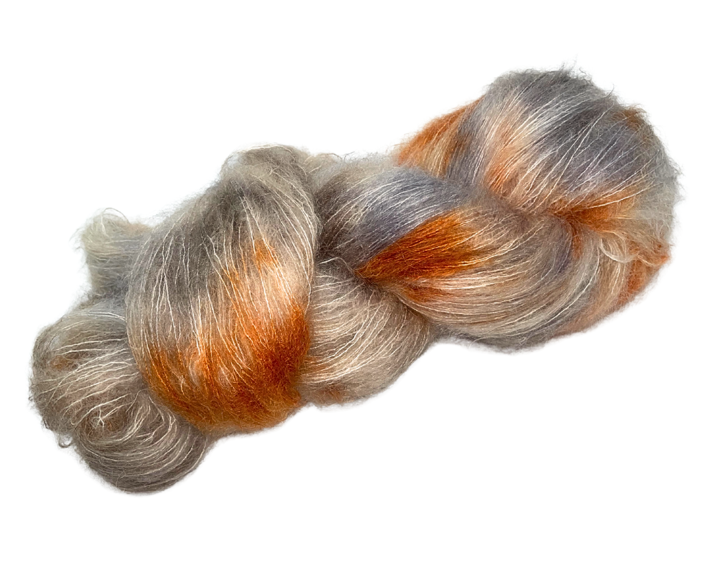 Nordic Star Yarns Silk/Mohair Lace in “Nordic Nightfall” hand painted in grey, beige, orange, brown, and a little bit of black