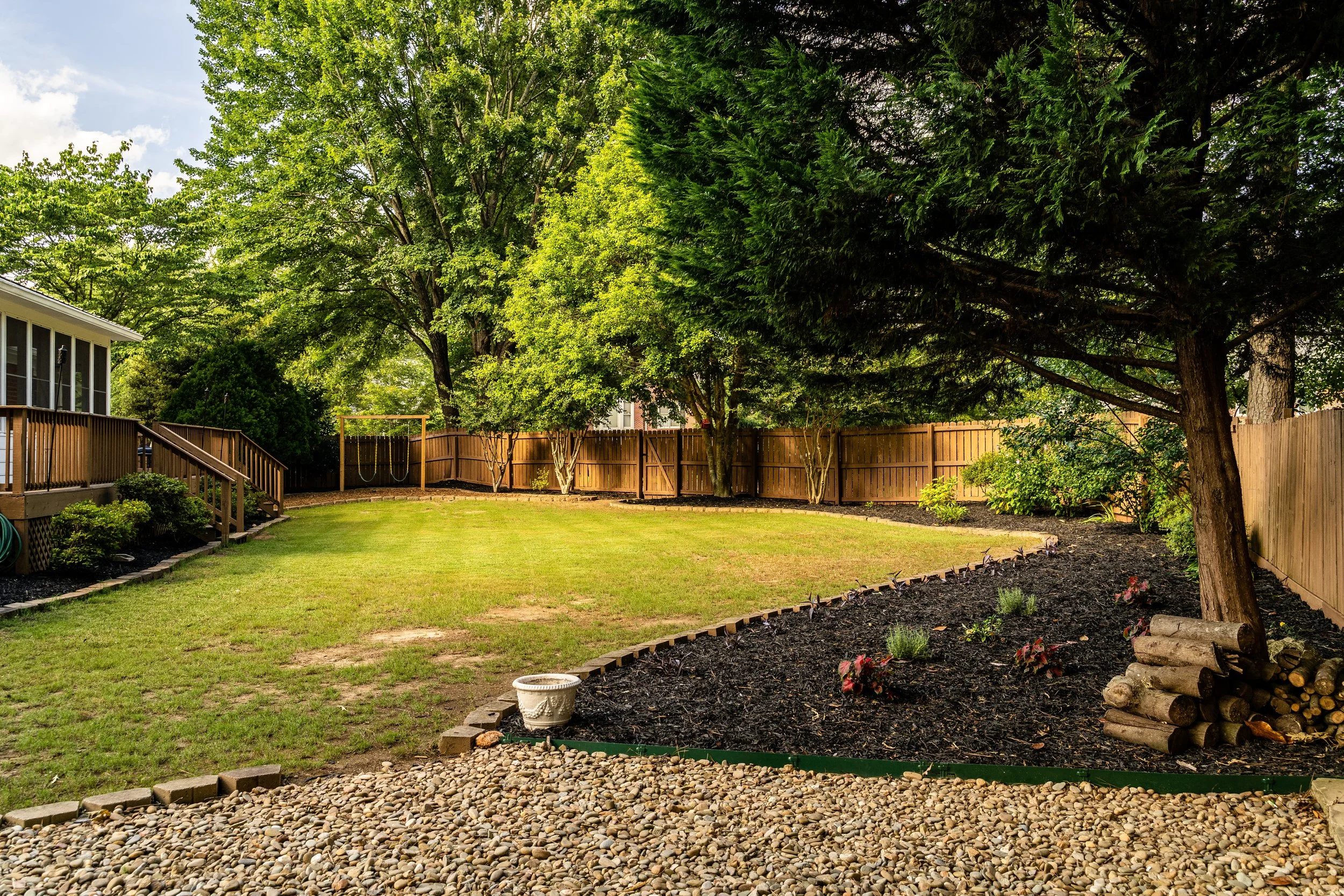 Backyard privacy fence with small landscape beds and shrubs creating a private outdoor space in Bear, Delaware