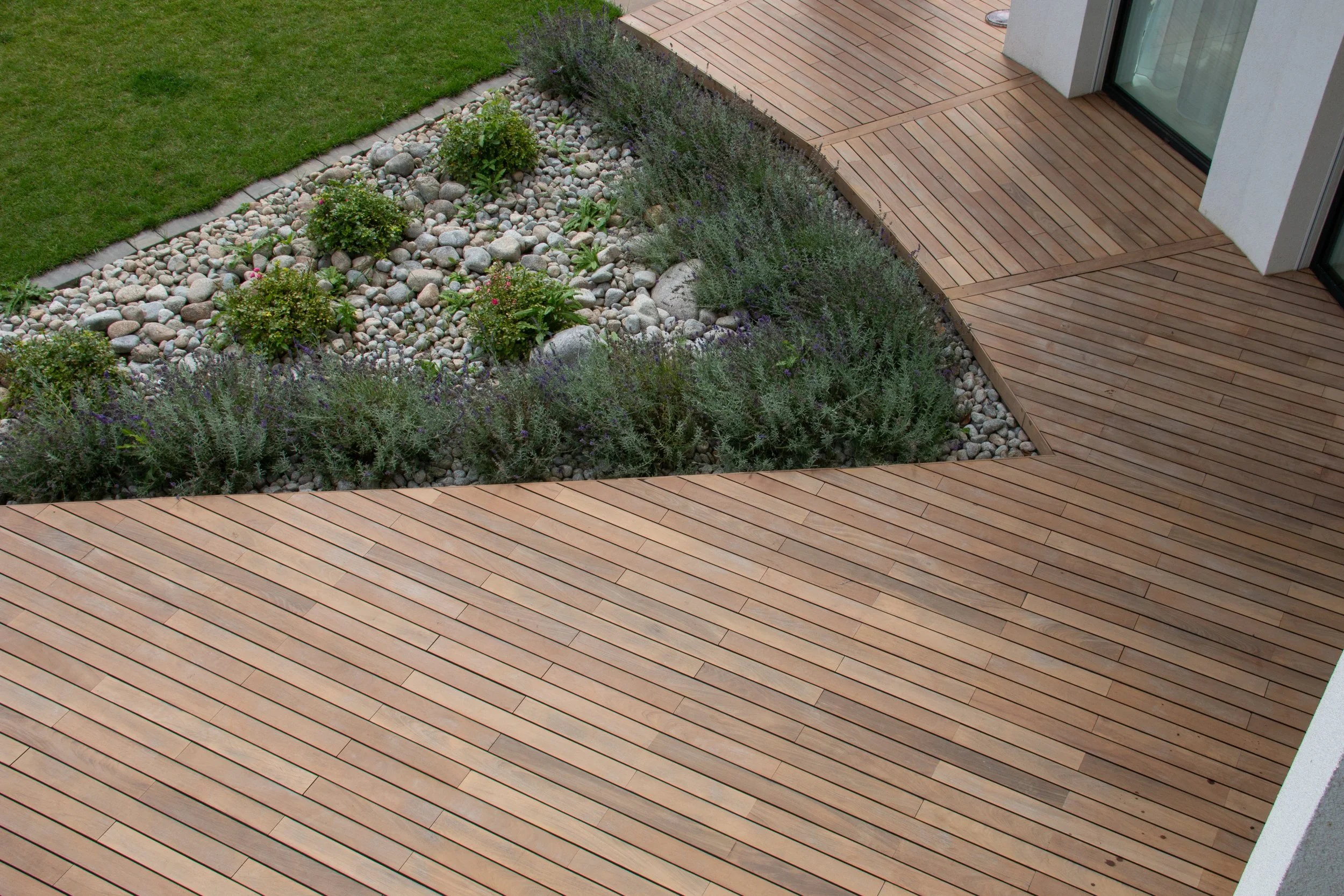 Wooden entrance walkway with minimalist landscaping designed to create a natural, park-like feel and welcoming commercial property entrance
