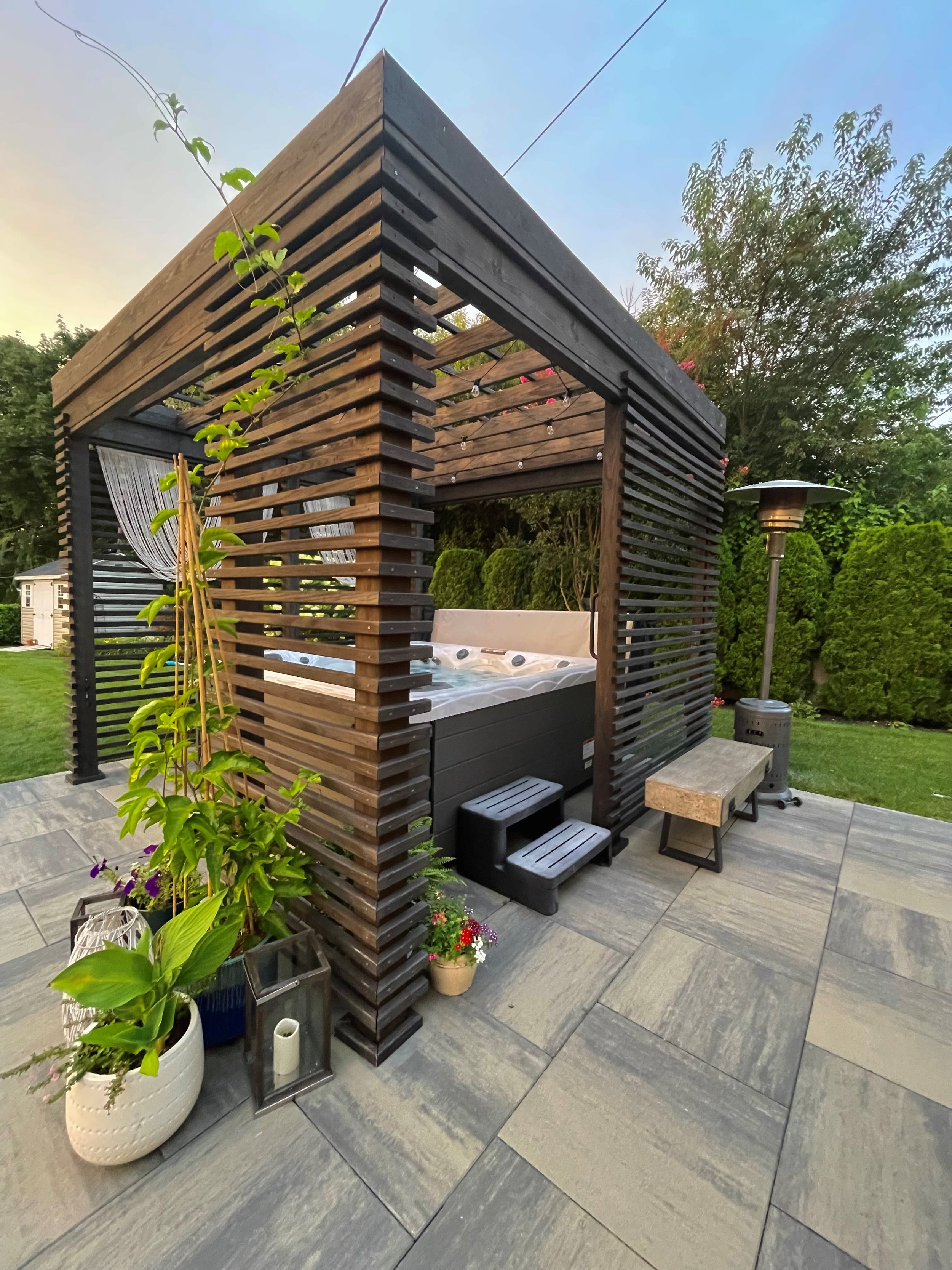 Belgard paver patio with hot tub enclosed seating area in Bear Delaware outdoor living space Excerpt: Belgard paver patio featuring a hot tub enclosed seating area creating a private outdoor living space in Bear Delaware