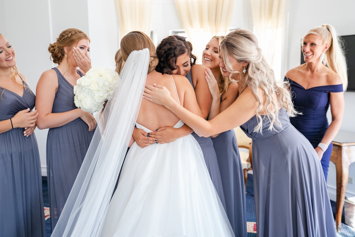 bride-and-bridesmaids-sharing-hugs.jpg