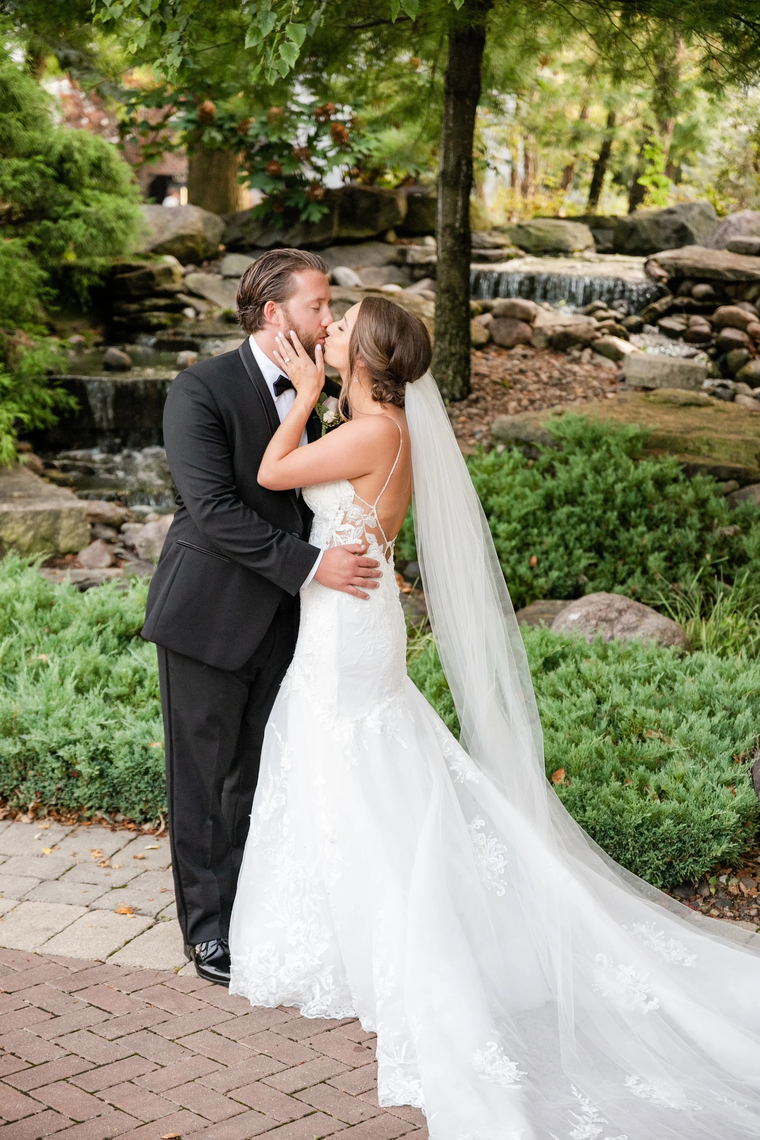 bride-and-groom-kissing-in-front-of-waterfall.jpg
