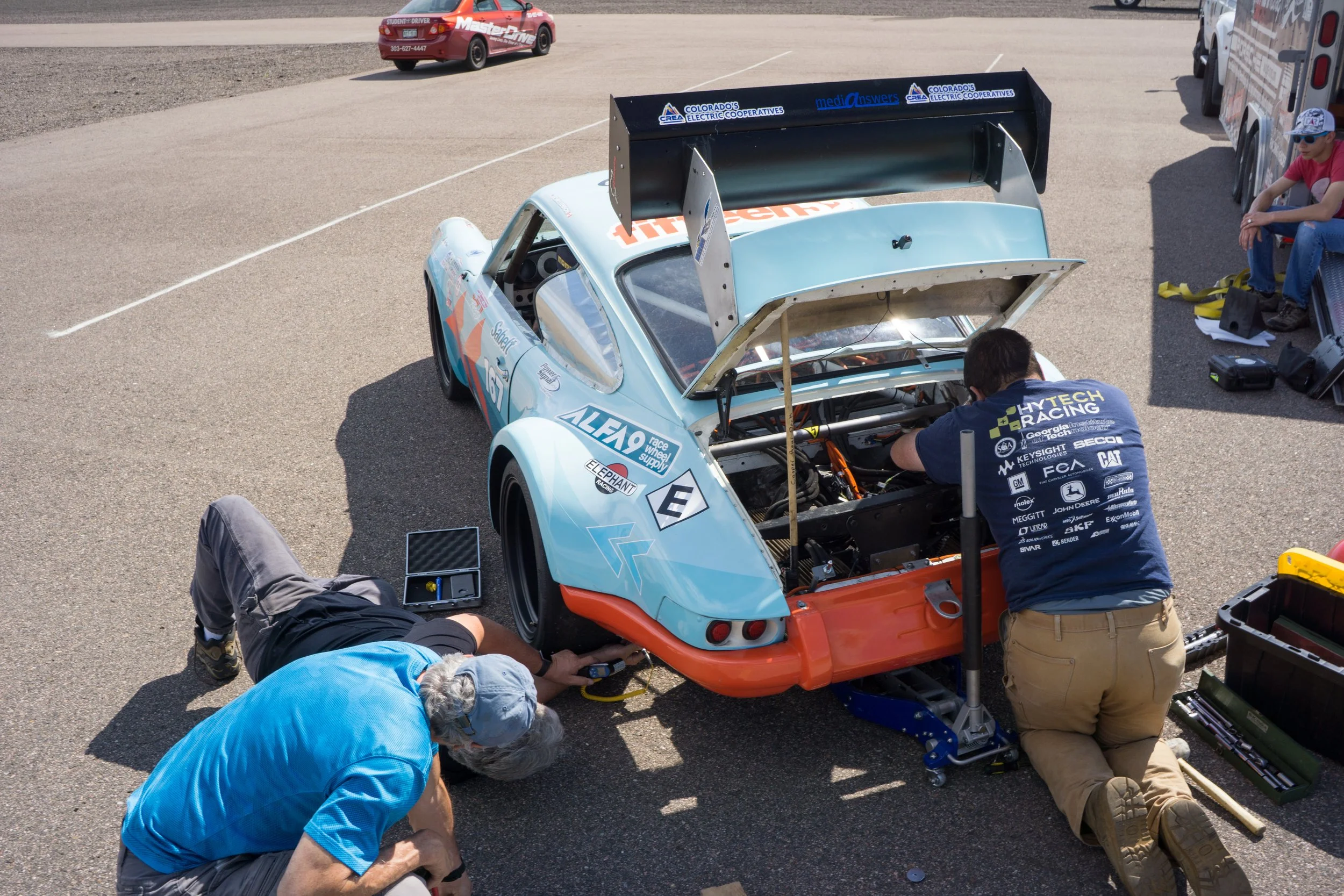 The team making adjustments to the car, still air cooled even now.