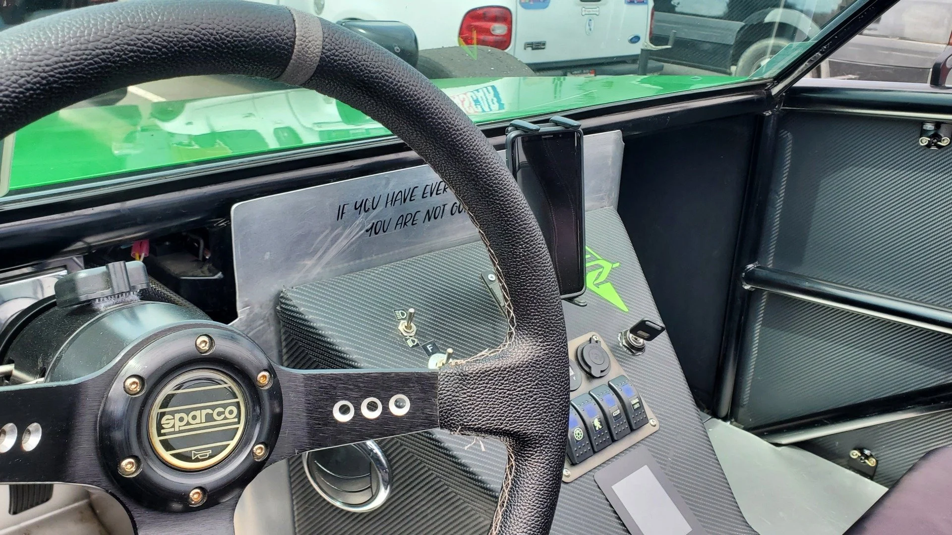 Interior of the Street Legal EV Race Car showing a Sparco wheel and controls