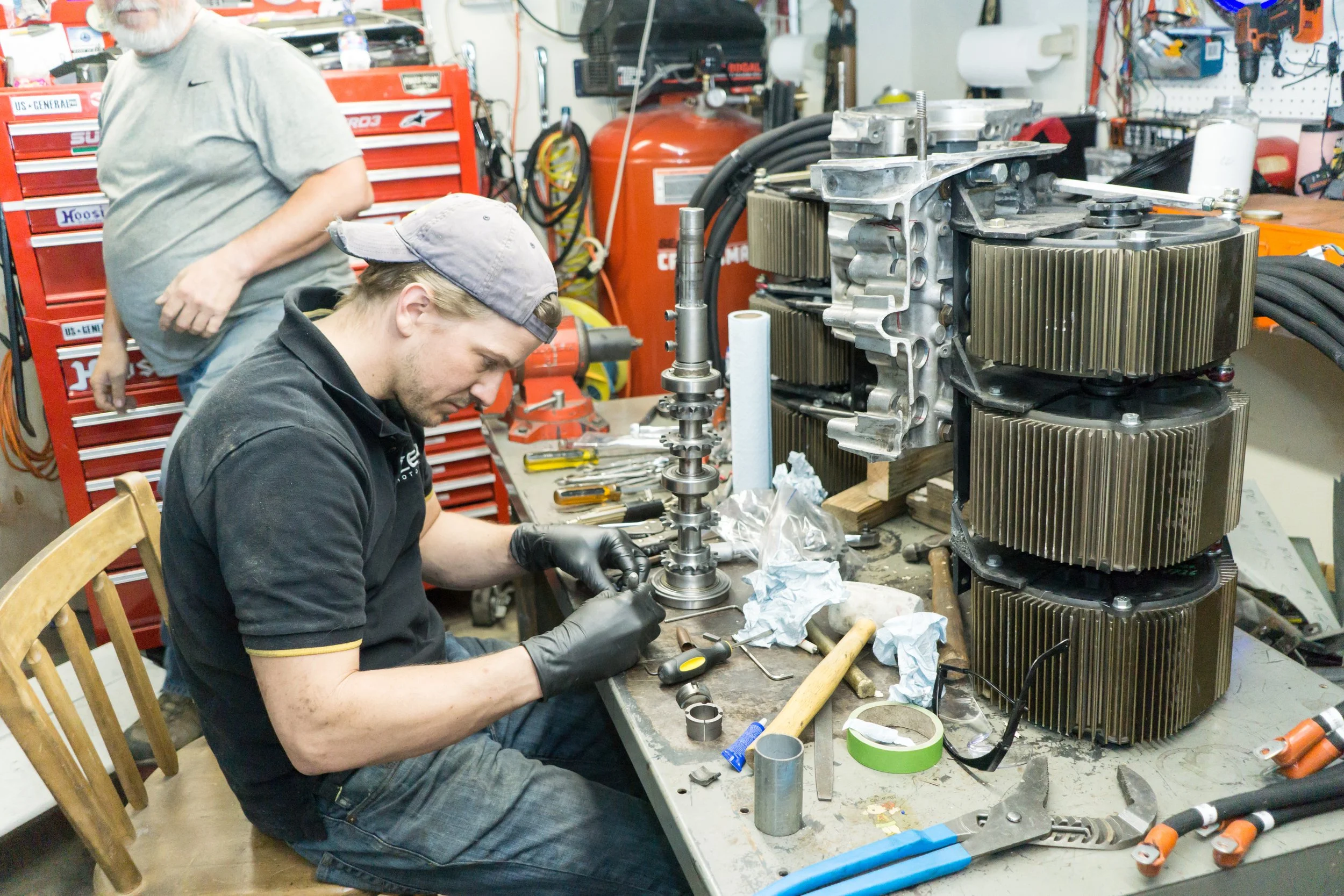 Micah working on a stack of Zero motors to go into the Porsche 911