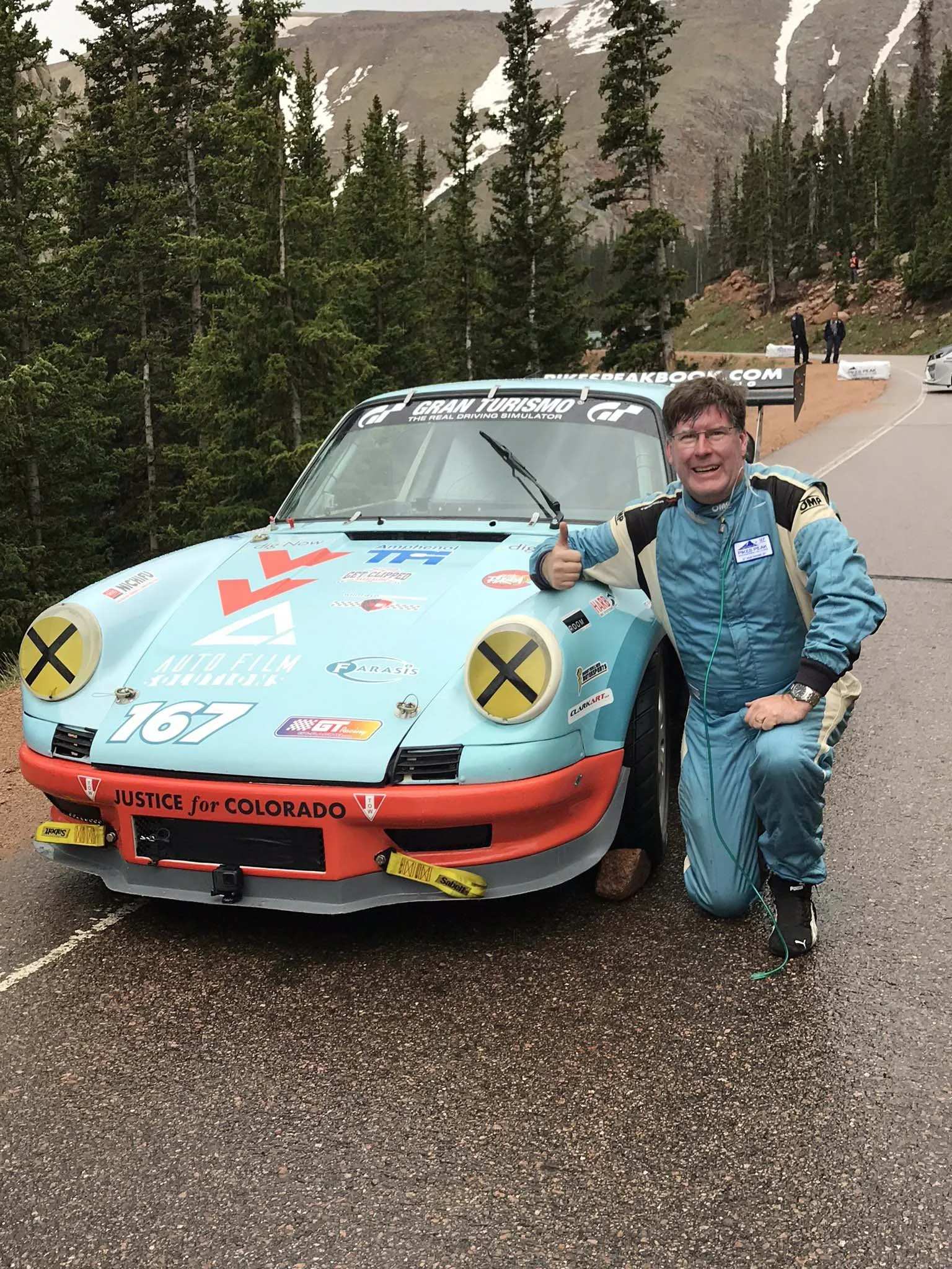 Chris Lennon with Casper the 911 posed at Pikes Peak