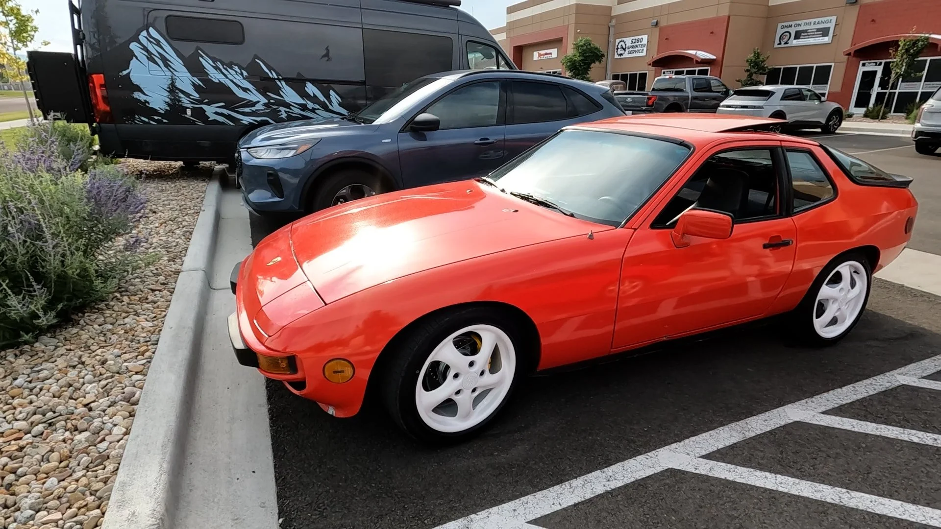 Image of a red porsche 924 parked in a parking lot