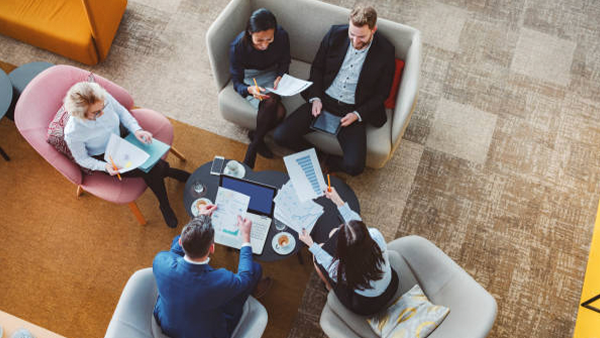 Professionals discussing documents together around a meeting table