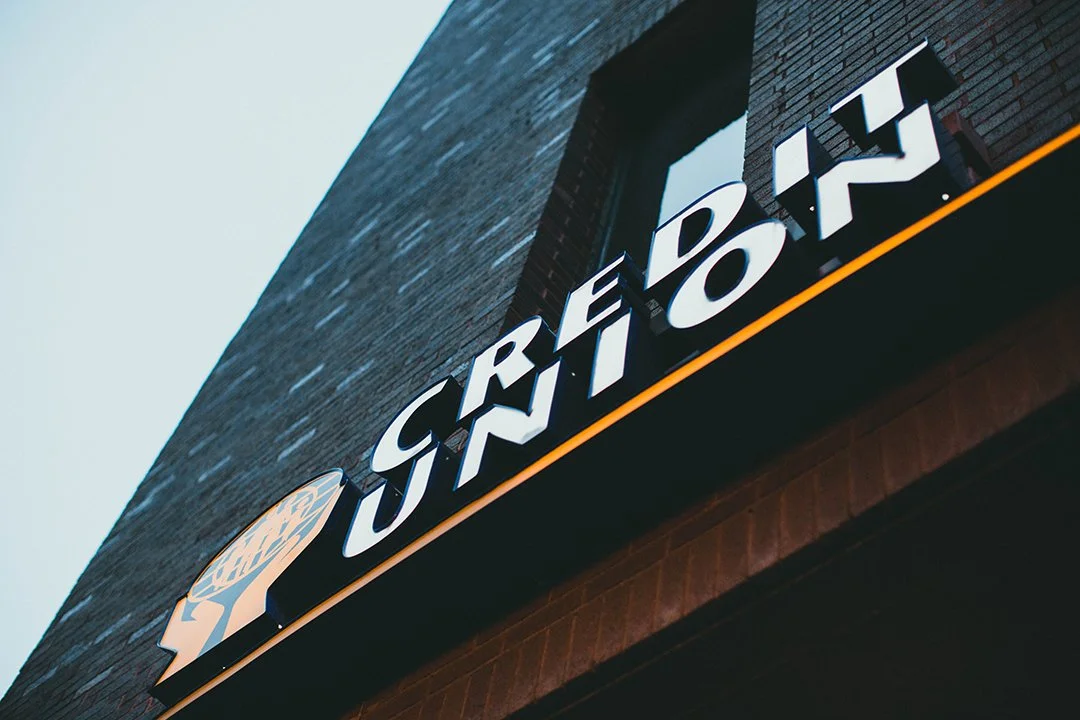 Close-up of a sign displaying the words 'CEREAL S.H.O.P.' on the exterior of a brick building.