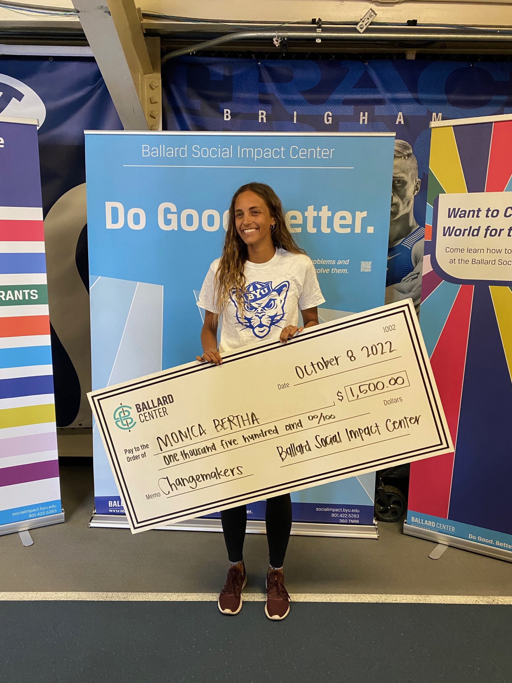 1st place winner from changemakers 2022, Monica Bertha, holding a check for $1,500