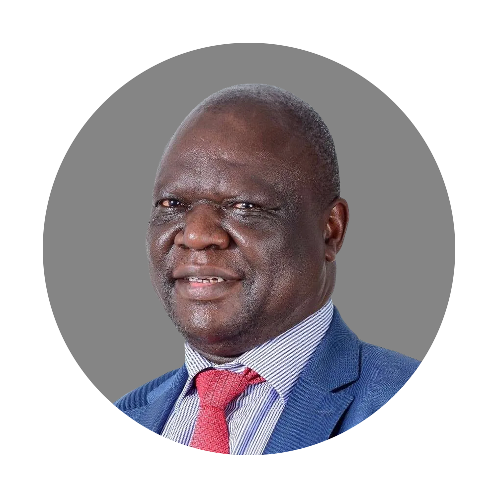 Portrait of a middle-aged man wearing a blue suit, striped shirt, and red tie, with short gray hair, against a gray background.
