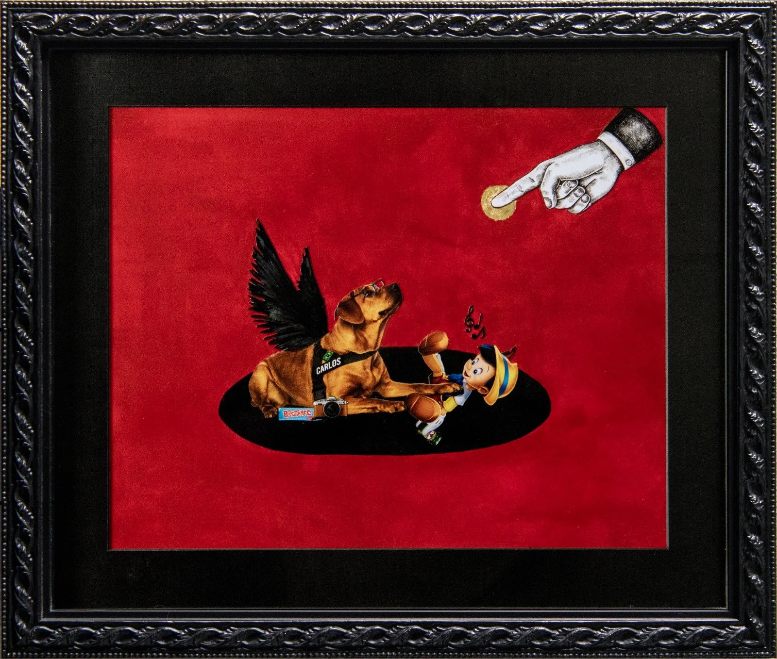 A framed collage featuring a realistic dog with black wings, labeled Carlos, lying on a black oval with a camera in front. Next to the dog is a cartoonish Pinocchio character dressed in a yellow hat and blue vest. Above, a black and white image of a 