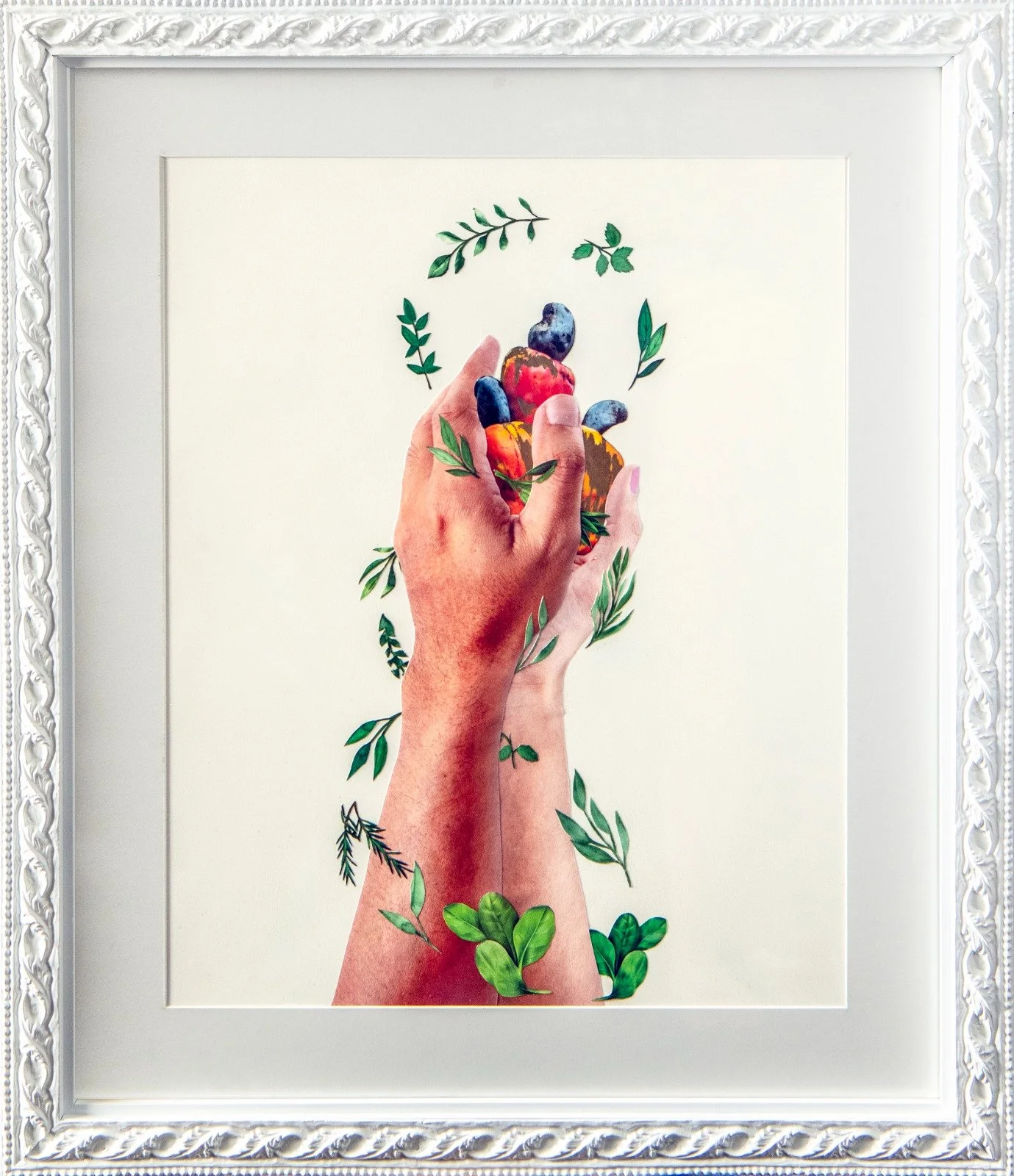 A framed artwork of two hands, one realistic and one illustrated, holding a cluster of berries and surrounded by green leaves. collage by Fabio Borges - Cura Series
