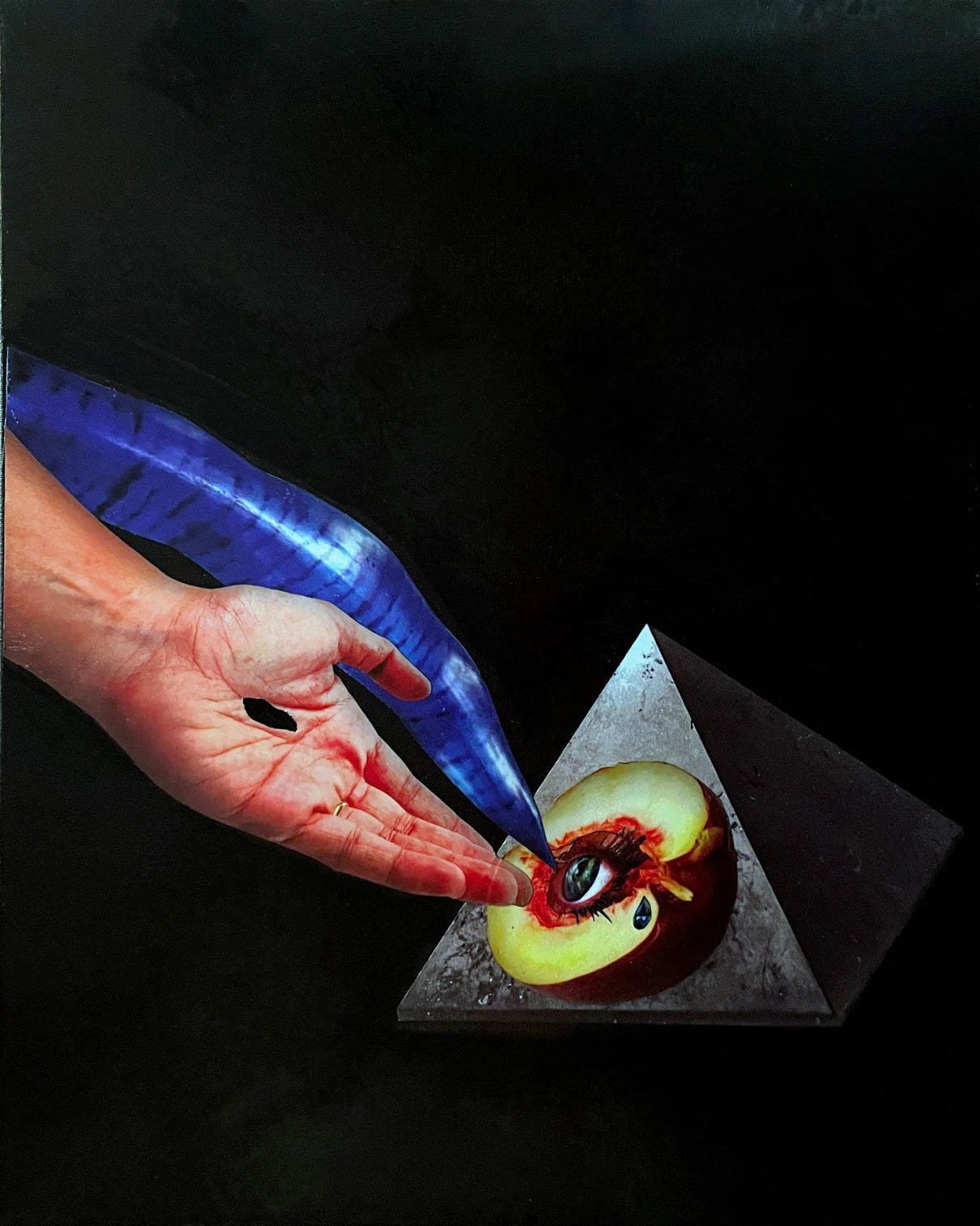 A hand holding a blue knife is about to cut into a partially sliced red and yellow apple with a human eye inside, placed on a pyramid-shaped stand against a black background. by Fabio Borges