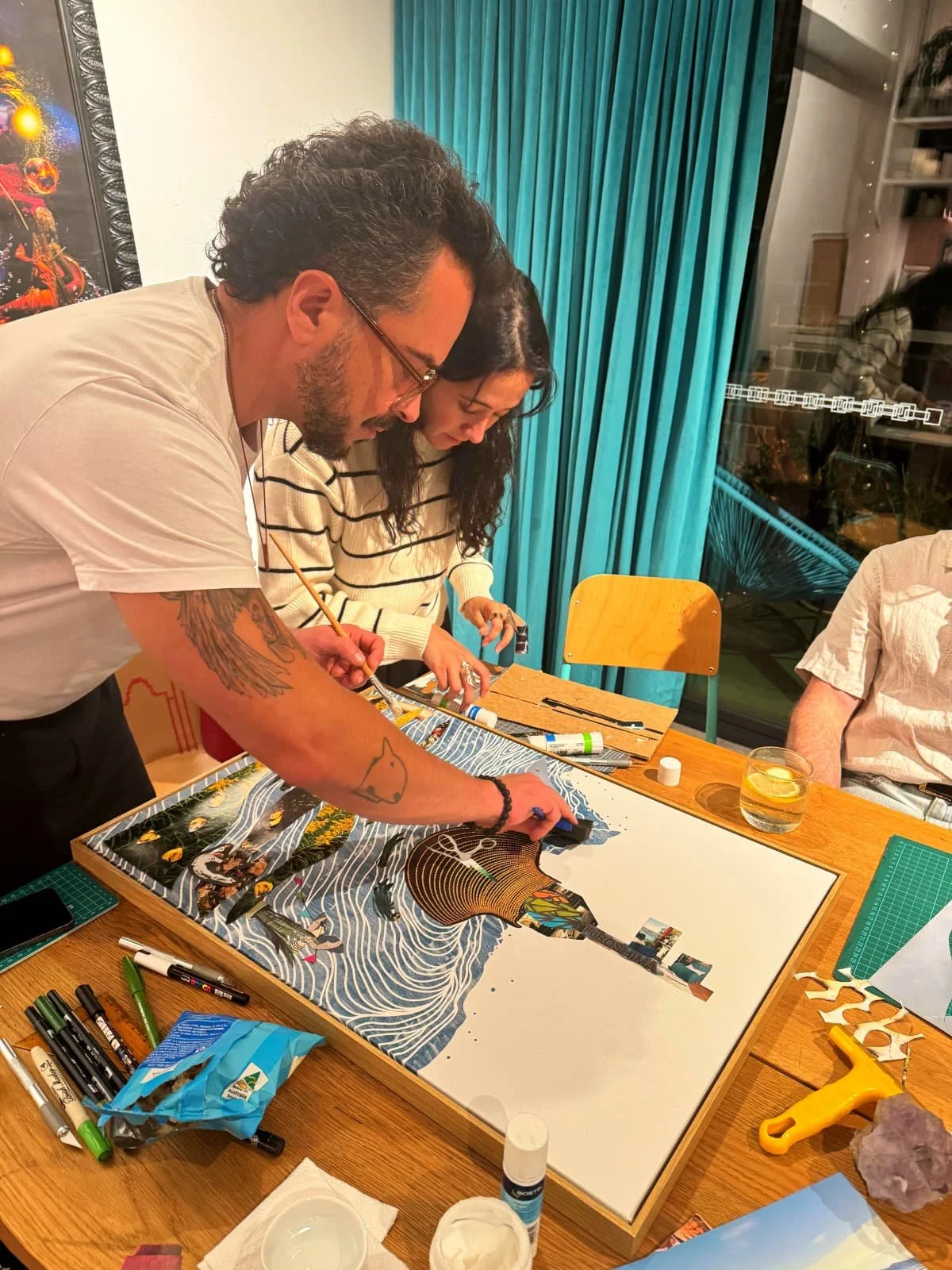 Fabio Borges helping a student out with a collage work