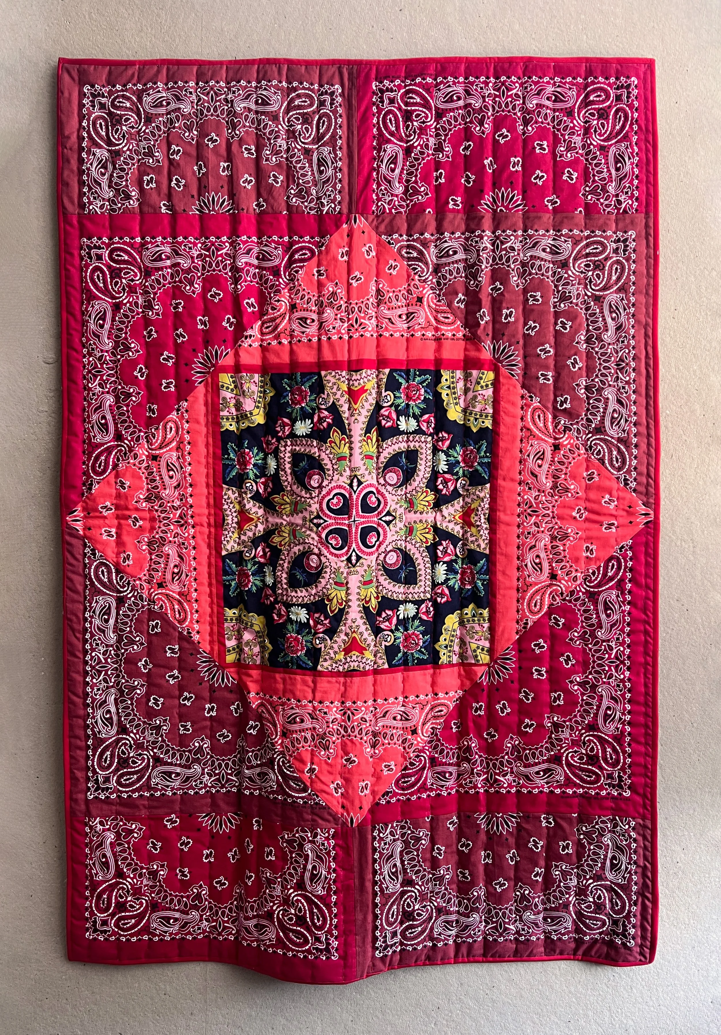 Inside of the blanket is quilted bandanas with running stitches