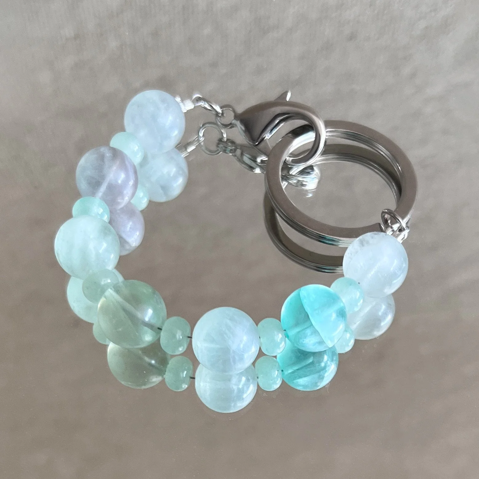 top view of fluorite bead bracelet on mirrored surface