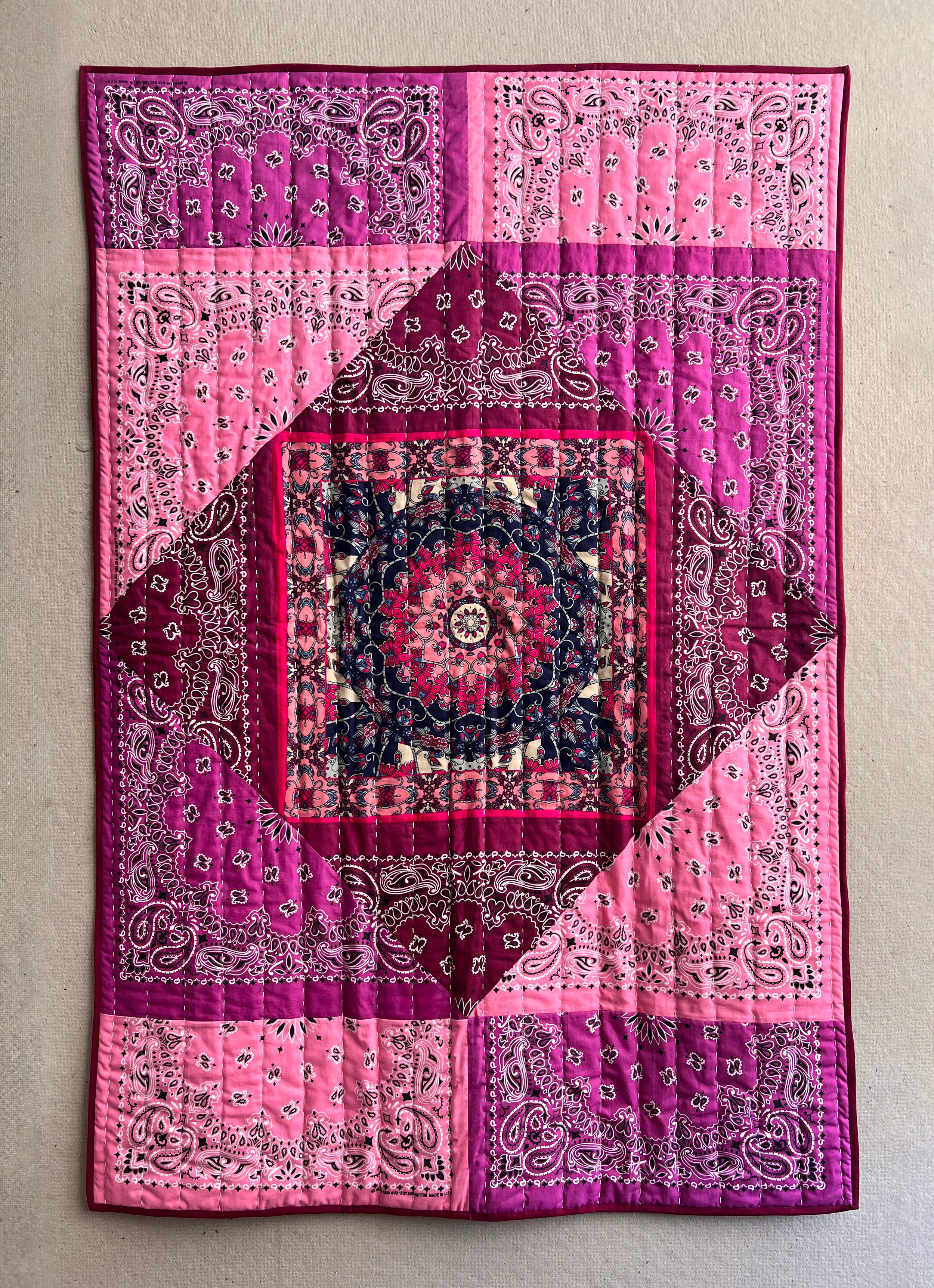 Inside of the blanket is quilted bandanas with running stitches