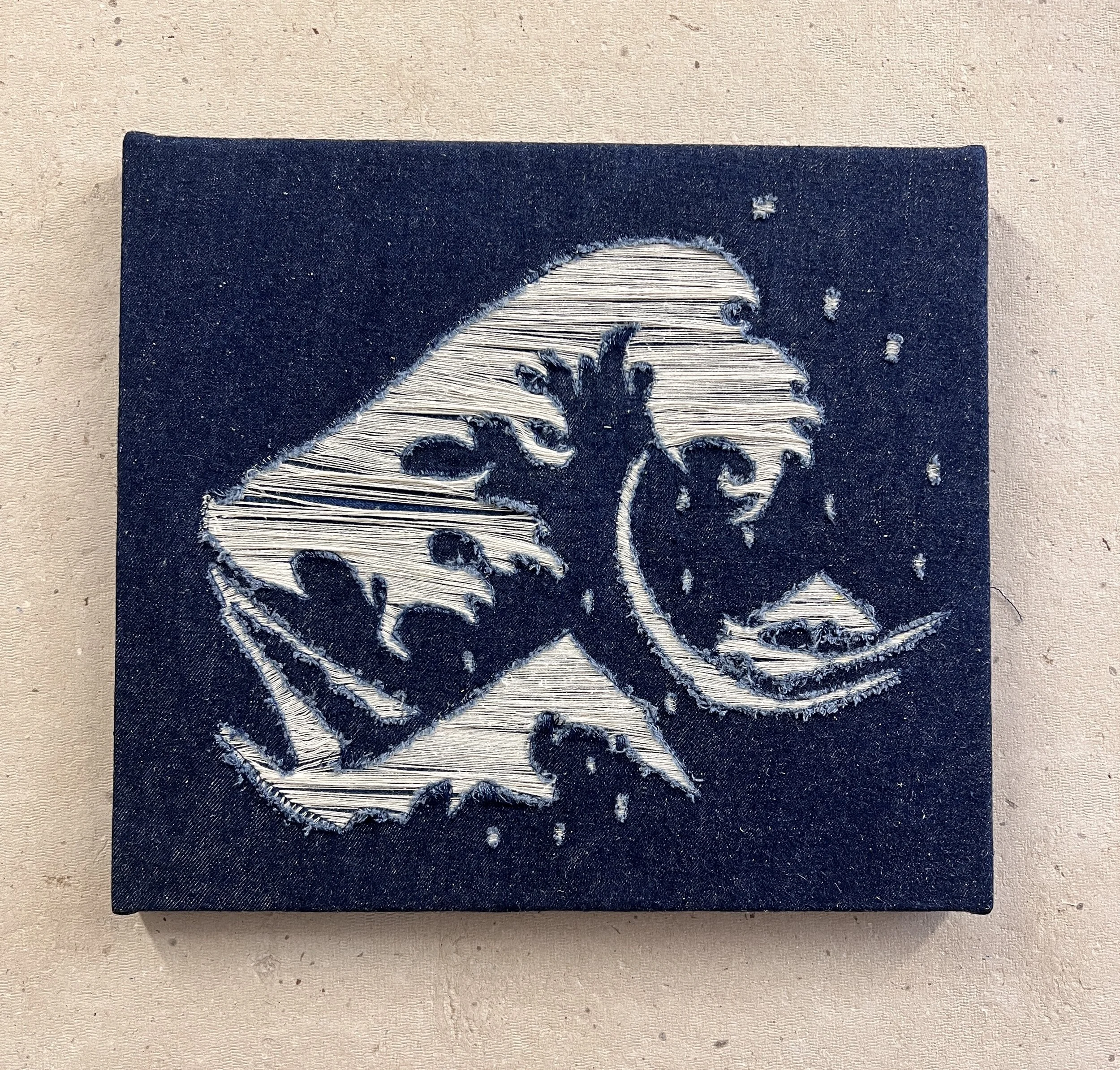 an interpretation of The Great Wave off Kanagawa in dark indigo denim utilizing detroy techniques