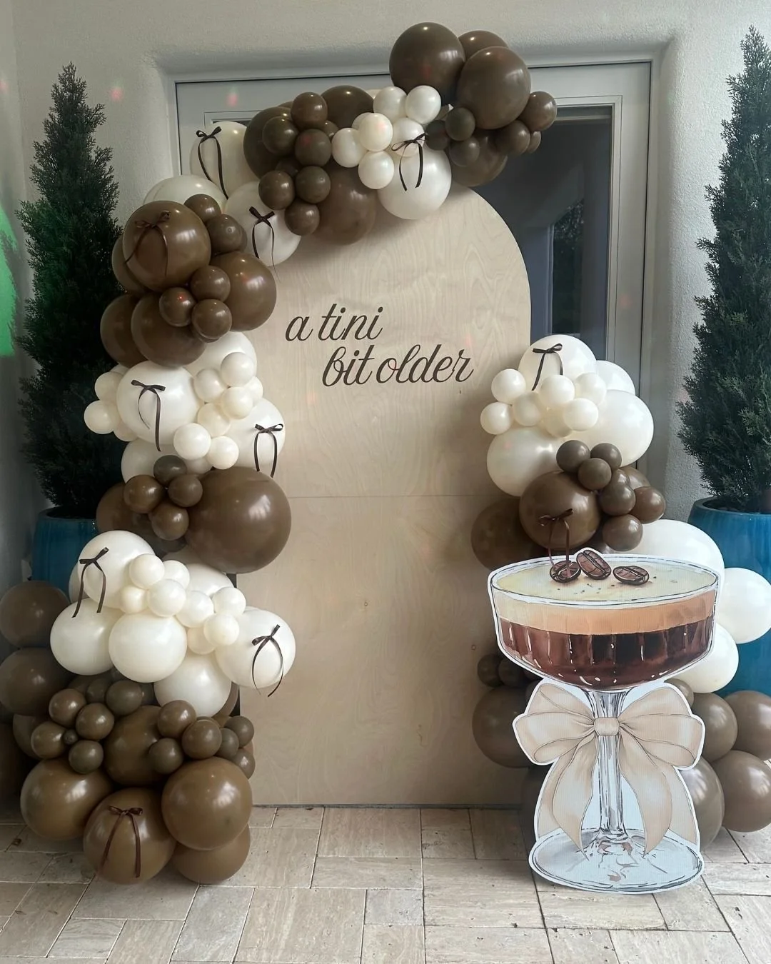 a tini bit older birthday backdrop and balloons