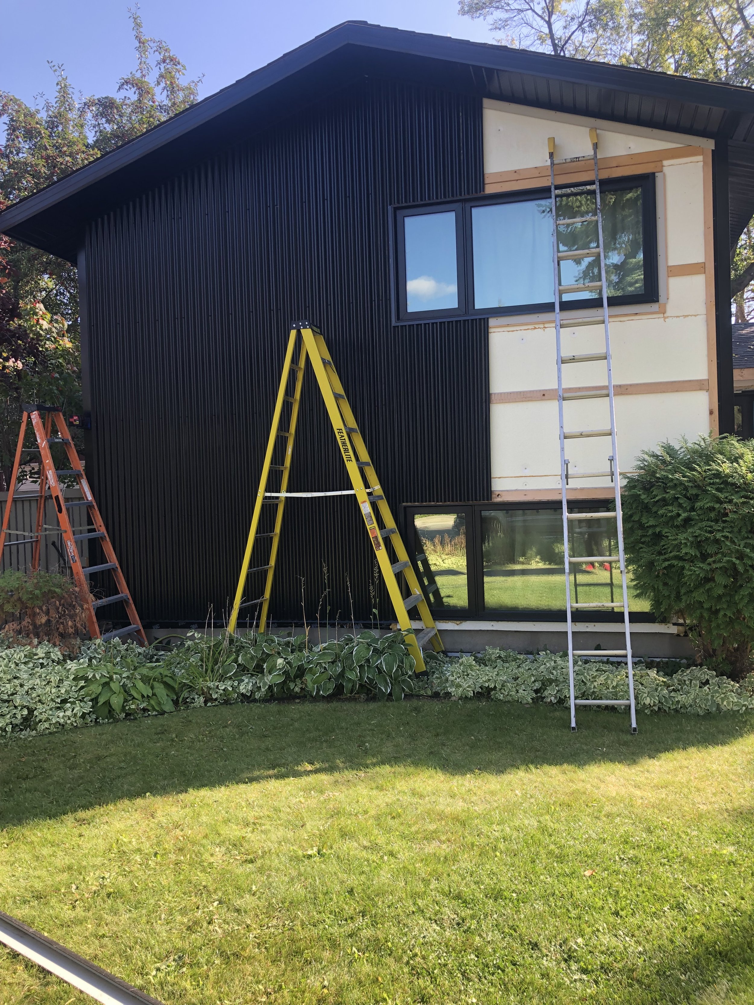 Mid Renovation - Black Metal Siding and Foam Installation - 2.jpg