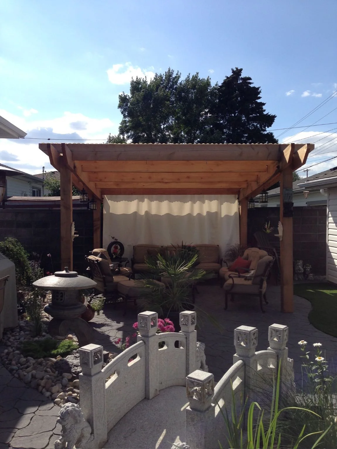 custom built pergola in landscaped city yard
