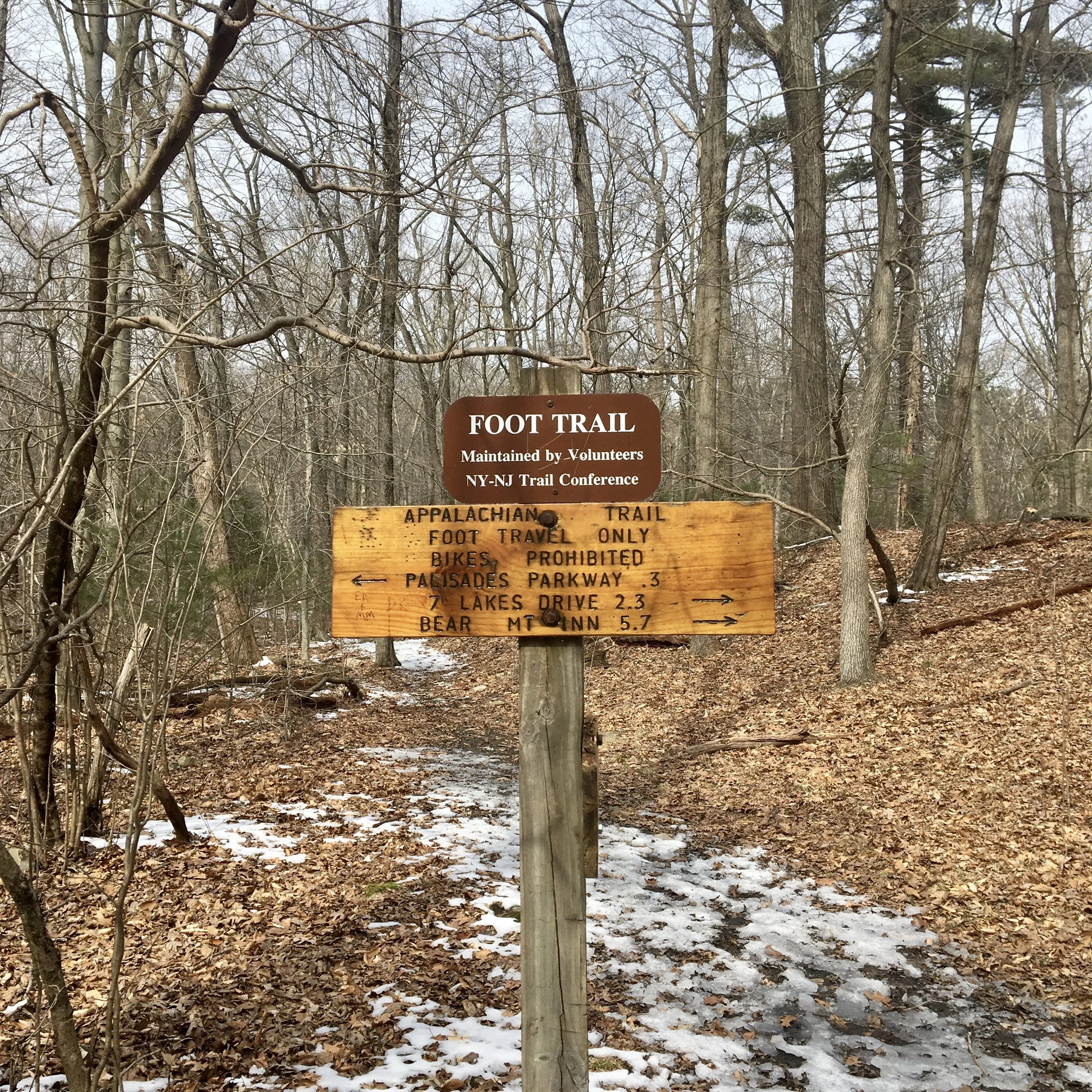 Trail sign denoting distance to nearby landmarks.