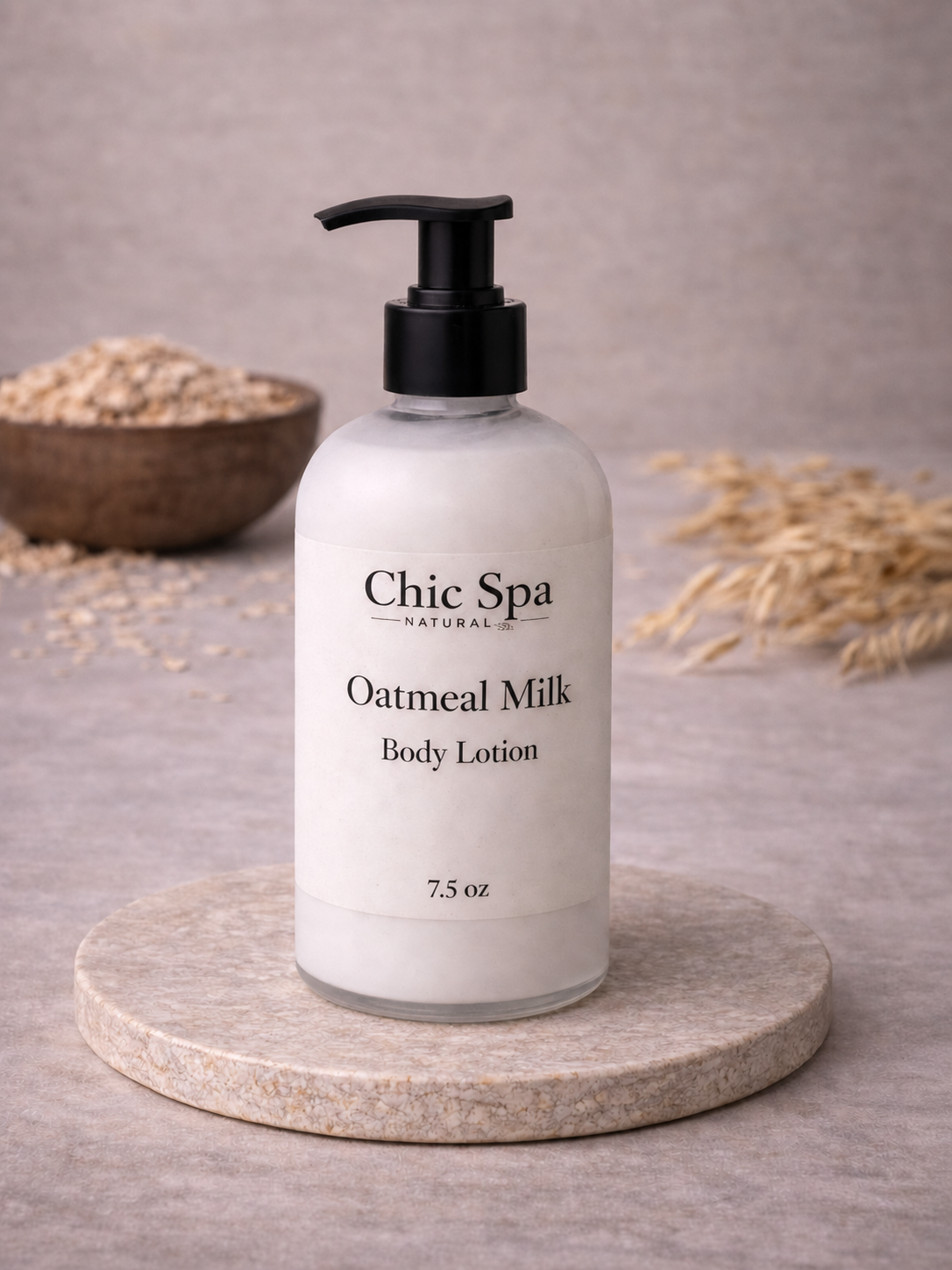Chic Spa Naturals Oatmeal Milk Body Lotion in a frosted glass bottle with black pump on a stone display with oat-inspired background accents.