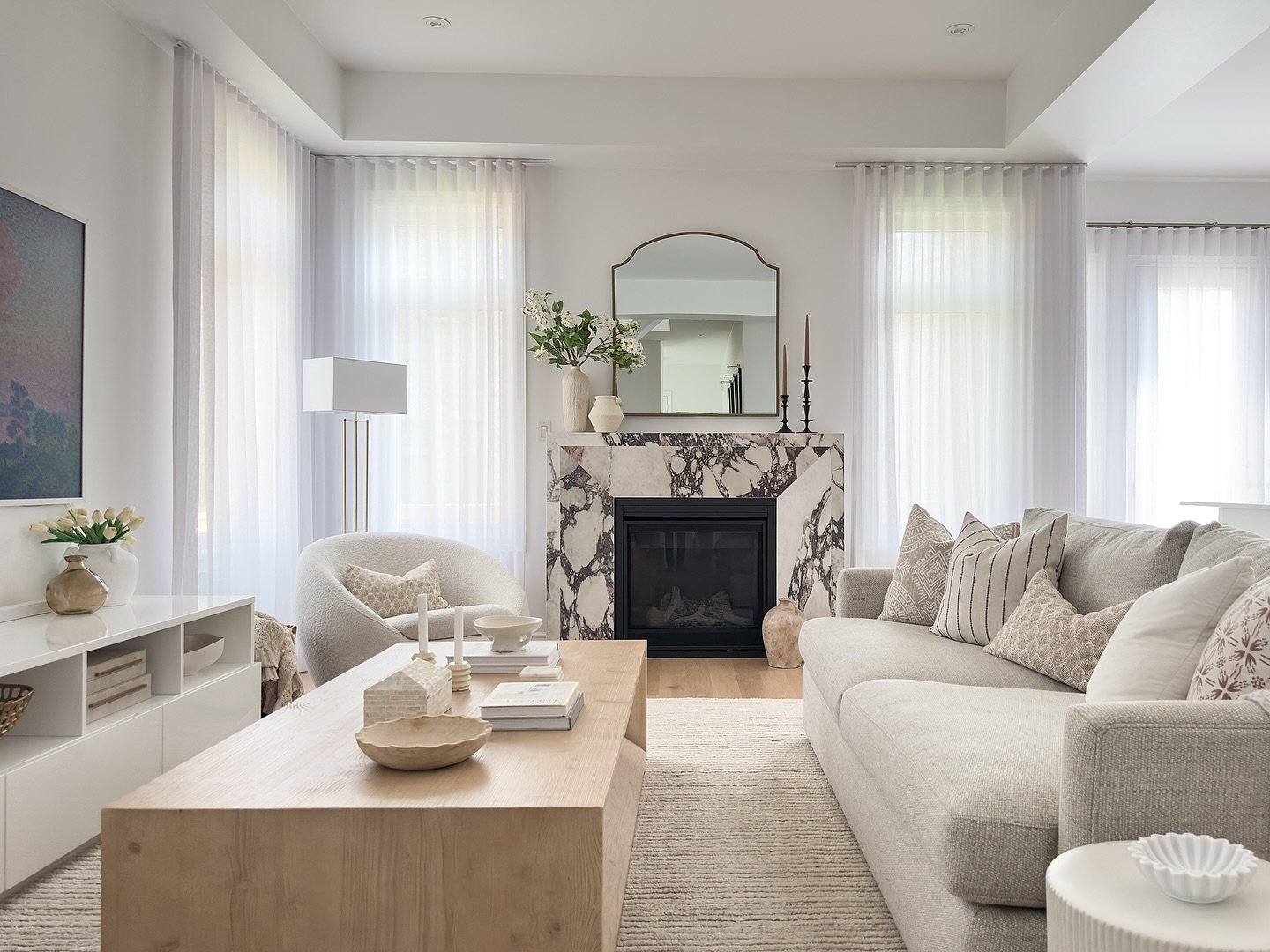 This is why you hire a decorator. 🪄✨

Same room - but with a vision.

What started as a basic builder-grade box has been completely transformed, now full of texture, warmth, balance, and a fireplace moment that steals the show.

If you&rsquo;re crav