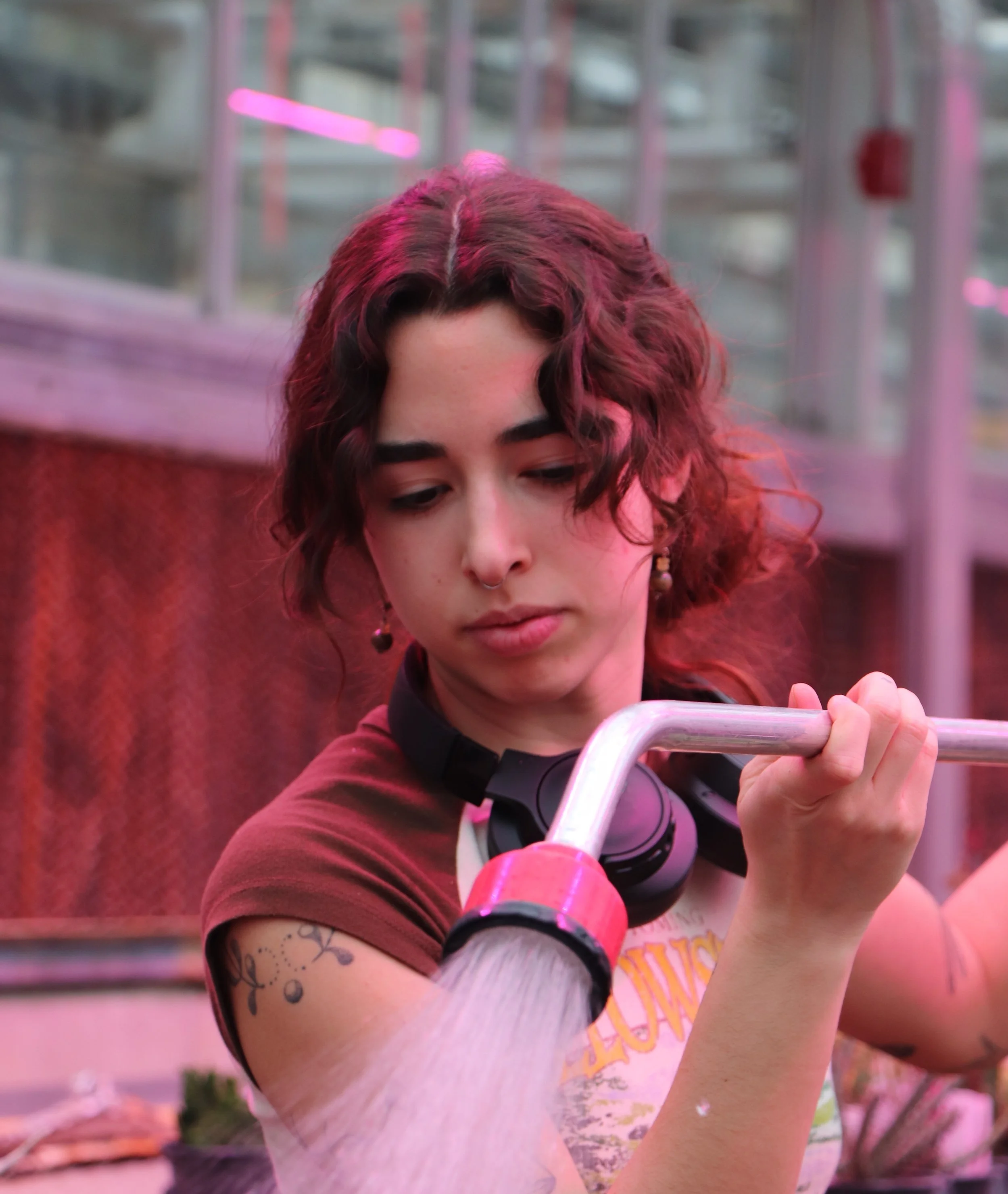After removing the dead plant parts, Paloma Adams waters any plants that show signs of dryness. She will continue to help propagate these leftover plants from the previous sale as the next one approaches in May.