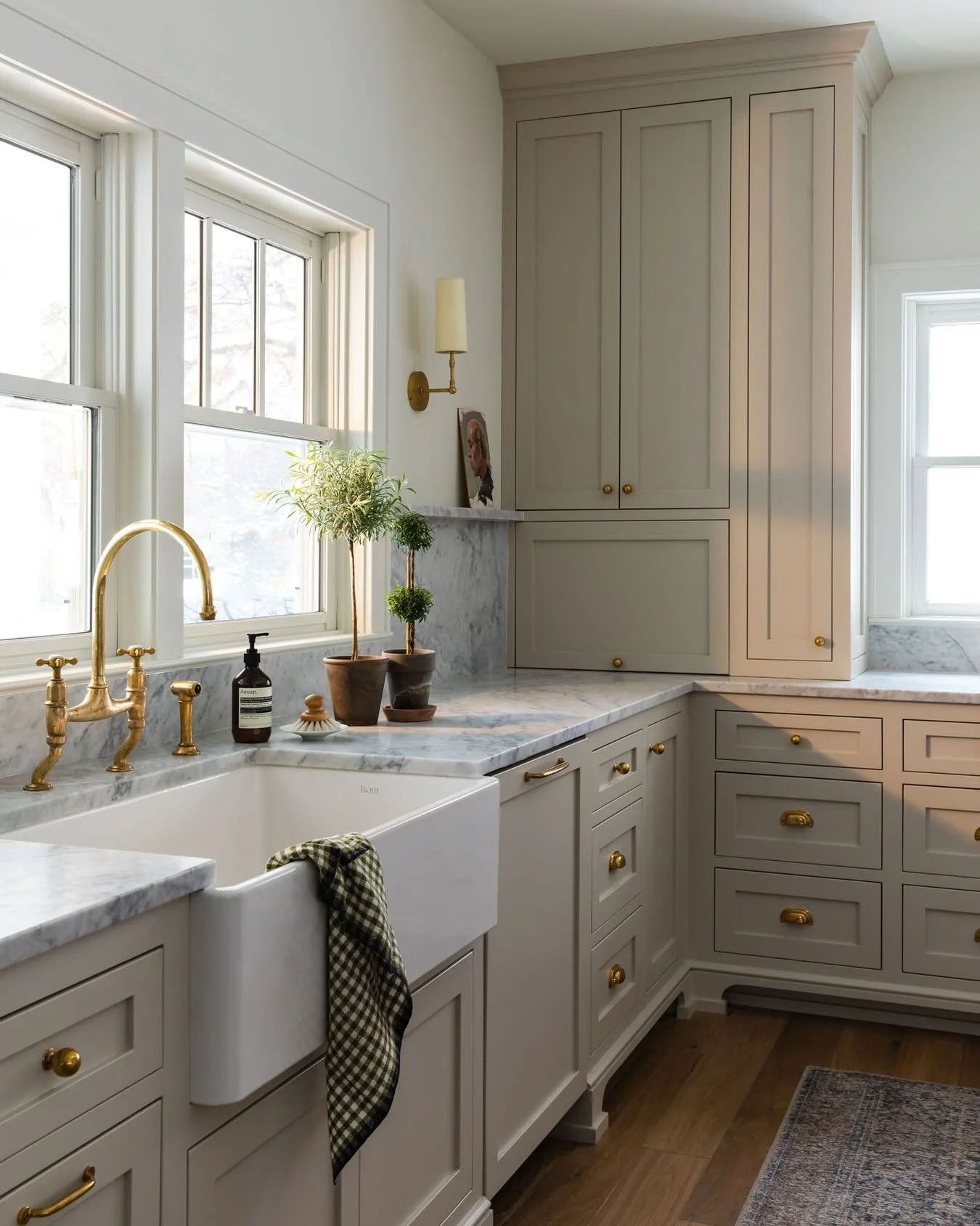 Every single design decision we made in this warm, welcoming galley kitchen makes our hearts sing. From the shallow shelf sitting above the marble half splash to the apron front, fireclay sink, unlacquered brass hardware (one of our favorite finishes