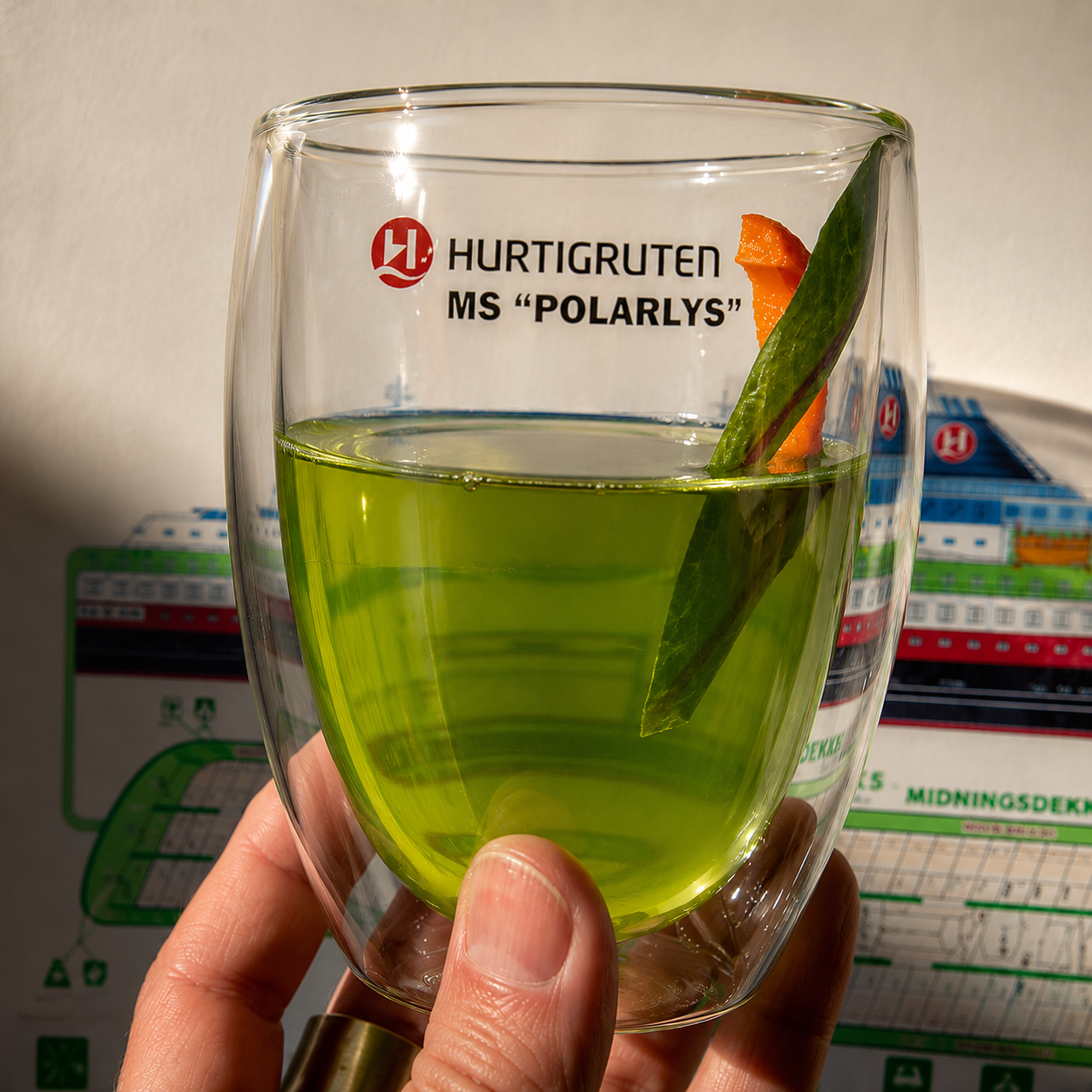 Hurtigruten tea drink with ship backdrop