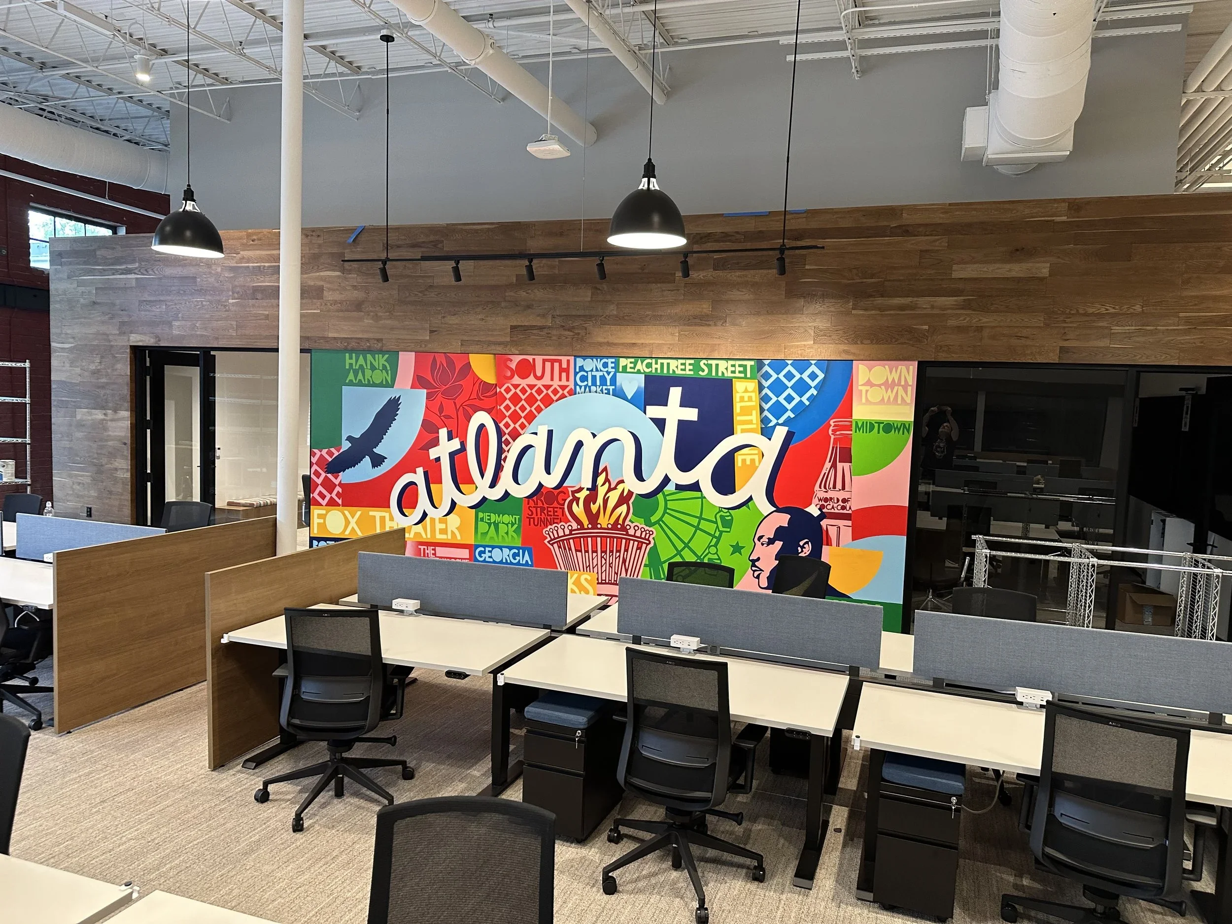 Office view of Google Fiber mural by John Tindel showcasing Atlanta's history.