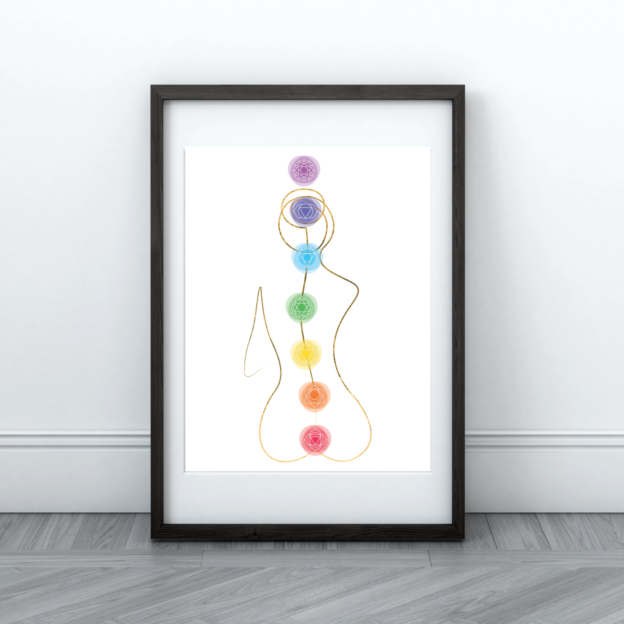 Framed artwork depicting a silhouette with chakra symbols and colors