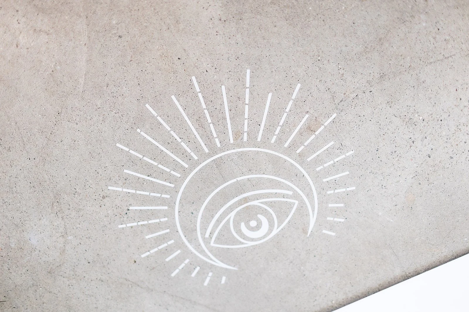 Abstract eye symbol on gray concrete background with radiating lines