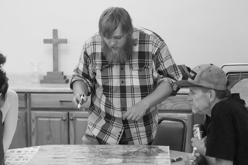 In the map exercise, the facilitator asks everyone to trace their history as a trip through life using a marker and the world map before them.