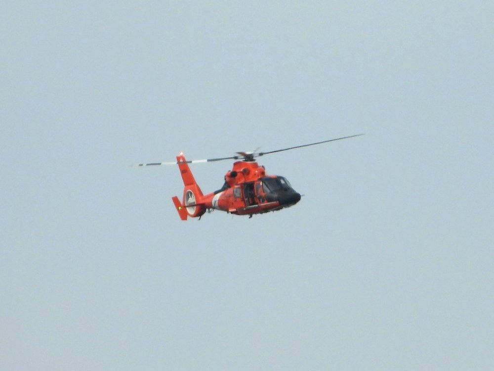 USCG Helicopter conducting air surveys