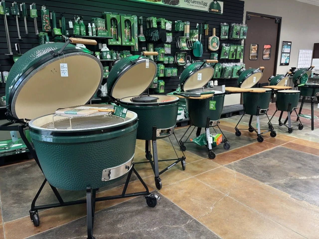 Wall filled with various Big Green Egg grilling accessories