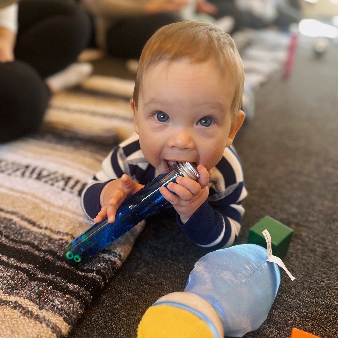 An adorable little explorer eating, I mean playing 😜with a sensory bottle lovingly made by his mama during today&rsquo;s Baby Sensory Circle session. #babysensorycircle