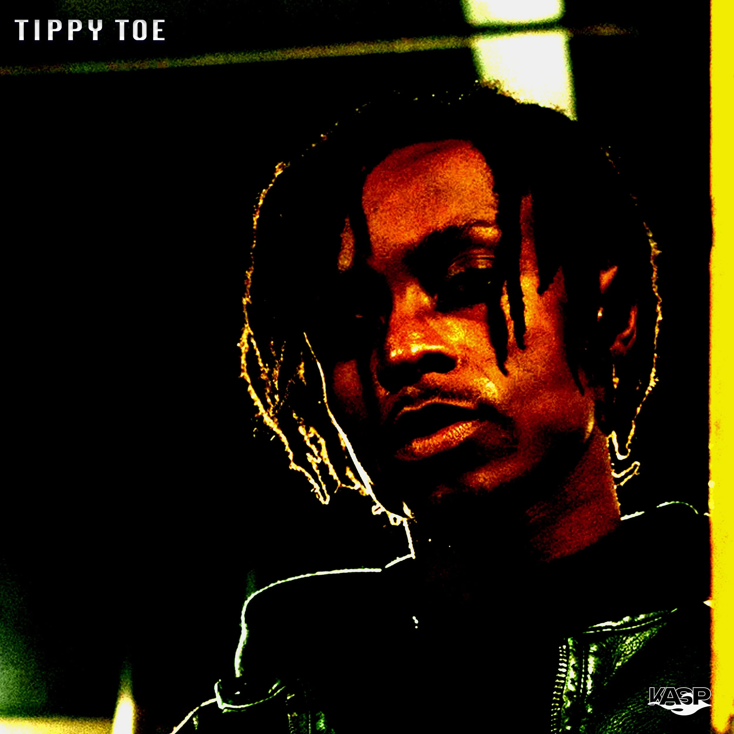 Close-up of a person's face with dreadlocks, with a dark, high-contrast filter and a black background. The person is wearing a jacket.