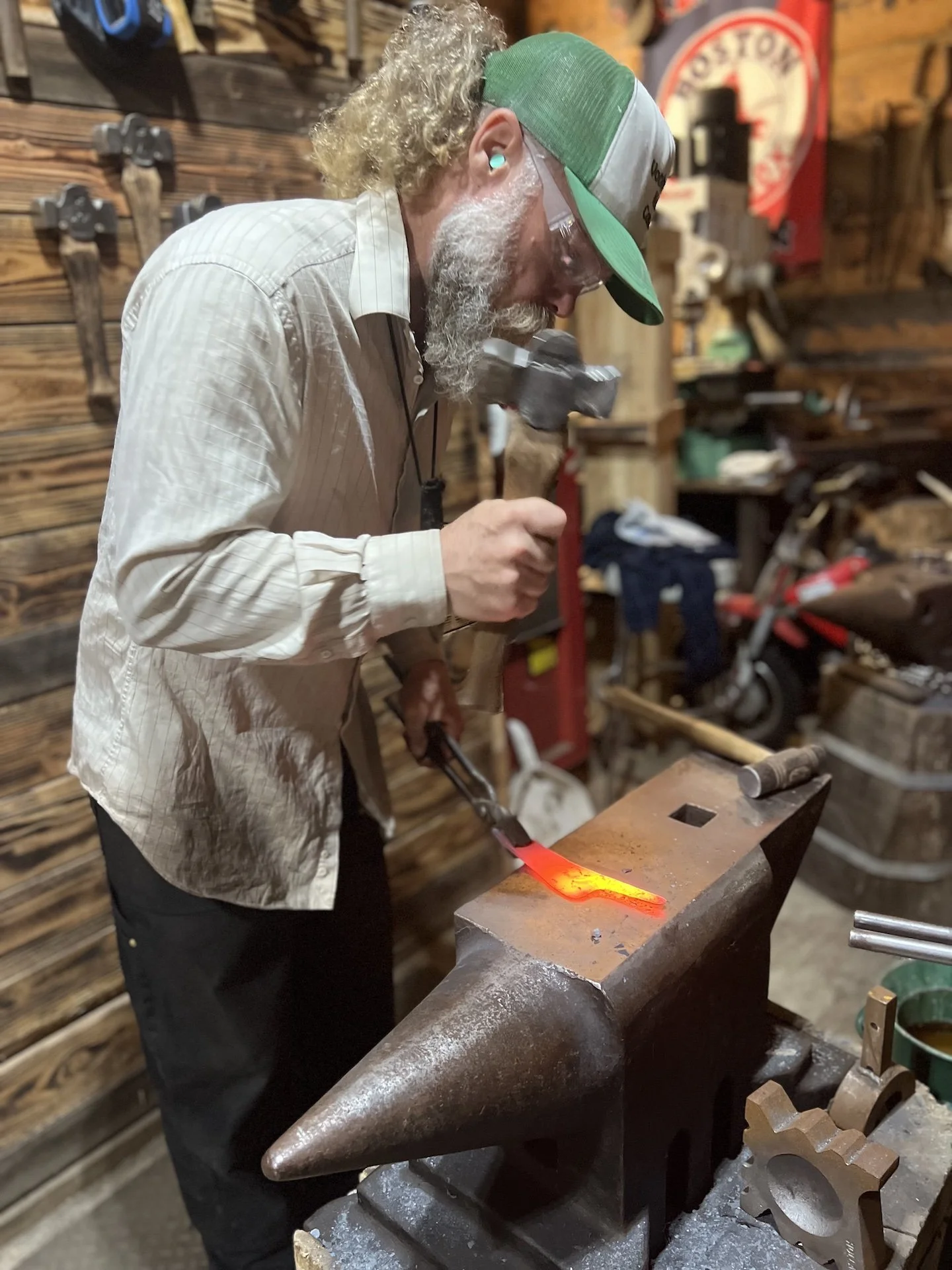 Gordon Hanson hammering a billet of premium Japanese blade steel on his anvil.