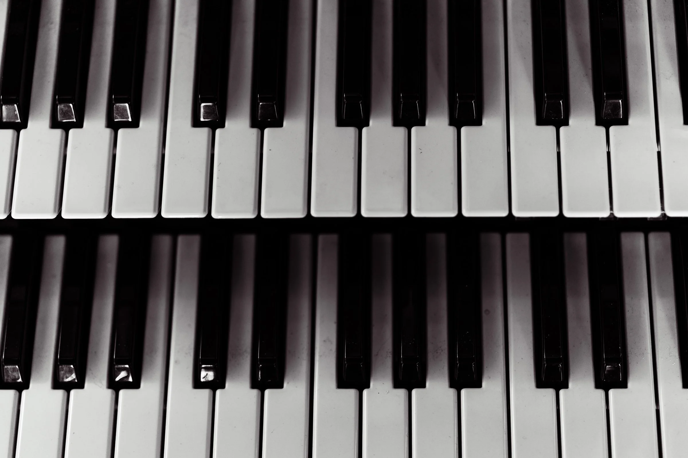Close-up of piano keys showing white and black keys.