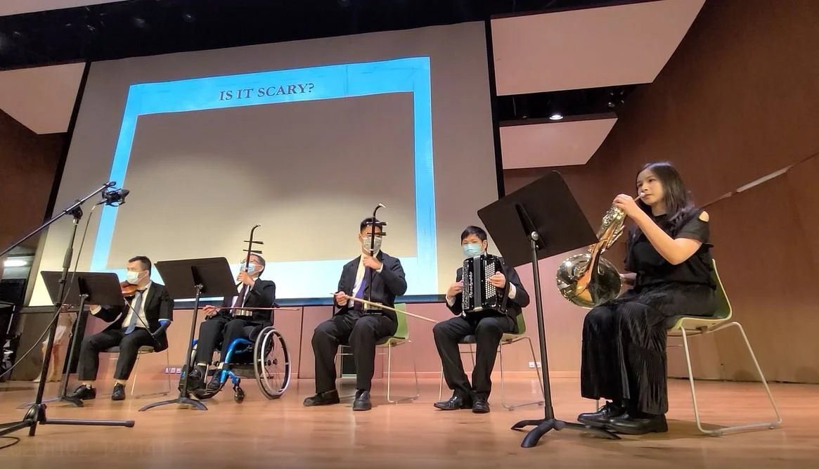 A mix of Chinese and Western instruments being performed together