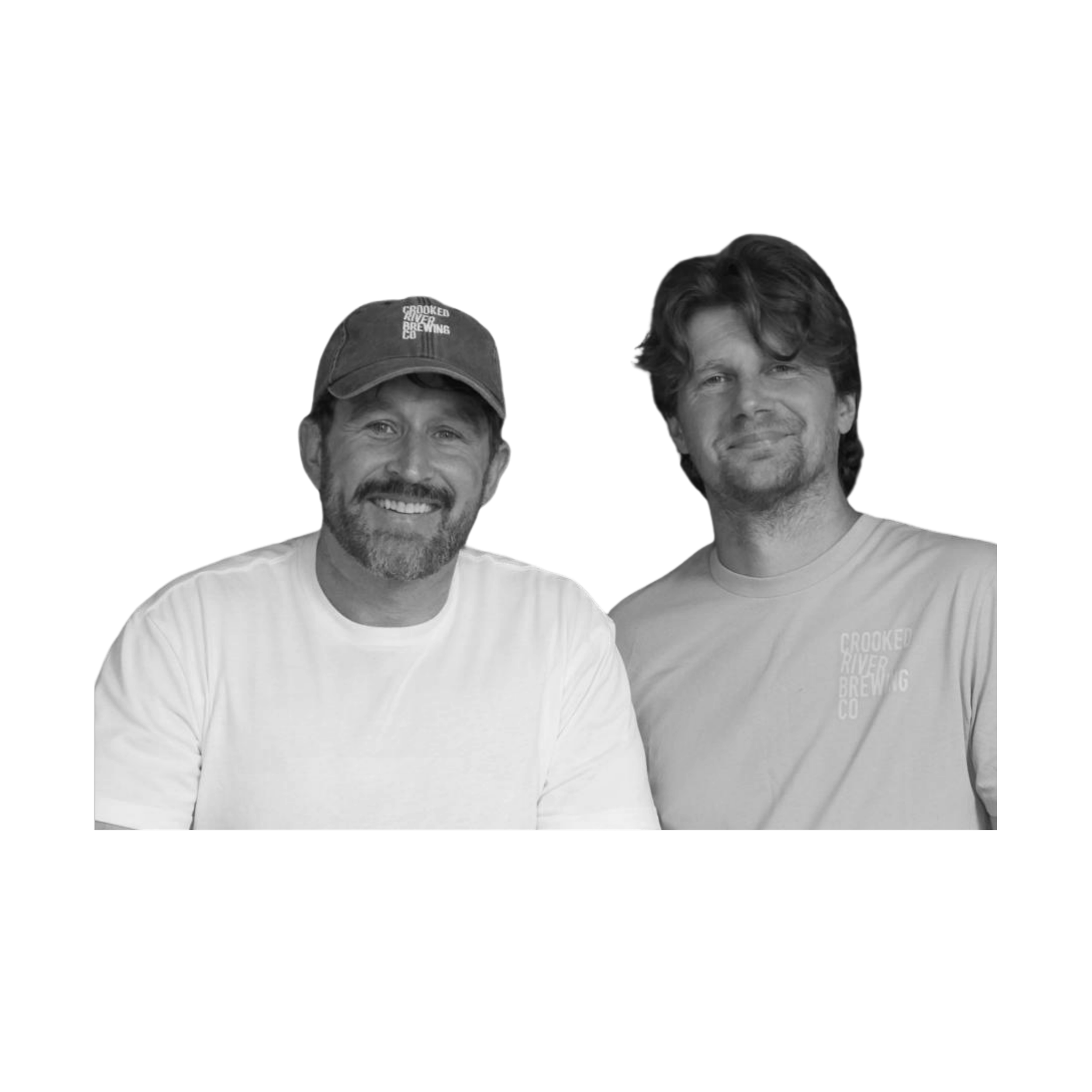 Black and white photo of two smiling men, one wearing a baseball cap that says 'Crooked River Brewing Co', and the other with curly hair. They are standing closely together against a dark background.