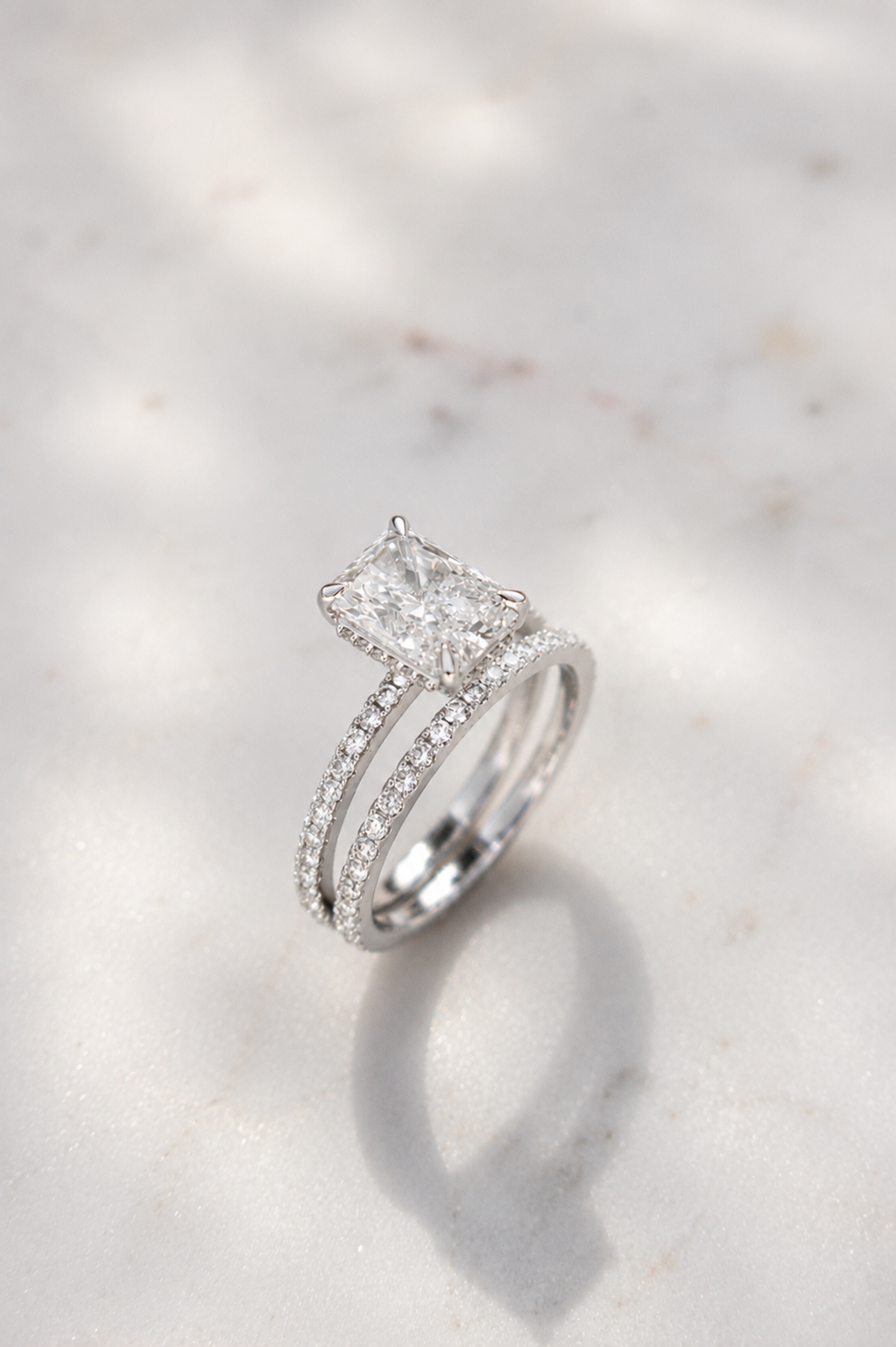 Platinum with 2ct radient cut diamond and diamond set shoulders with matching ring by Sophie Cudworth