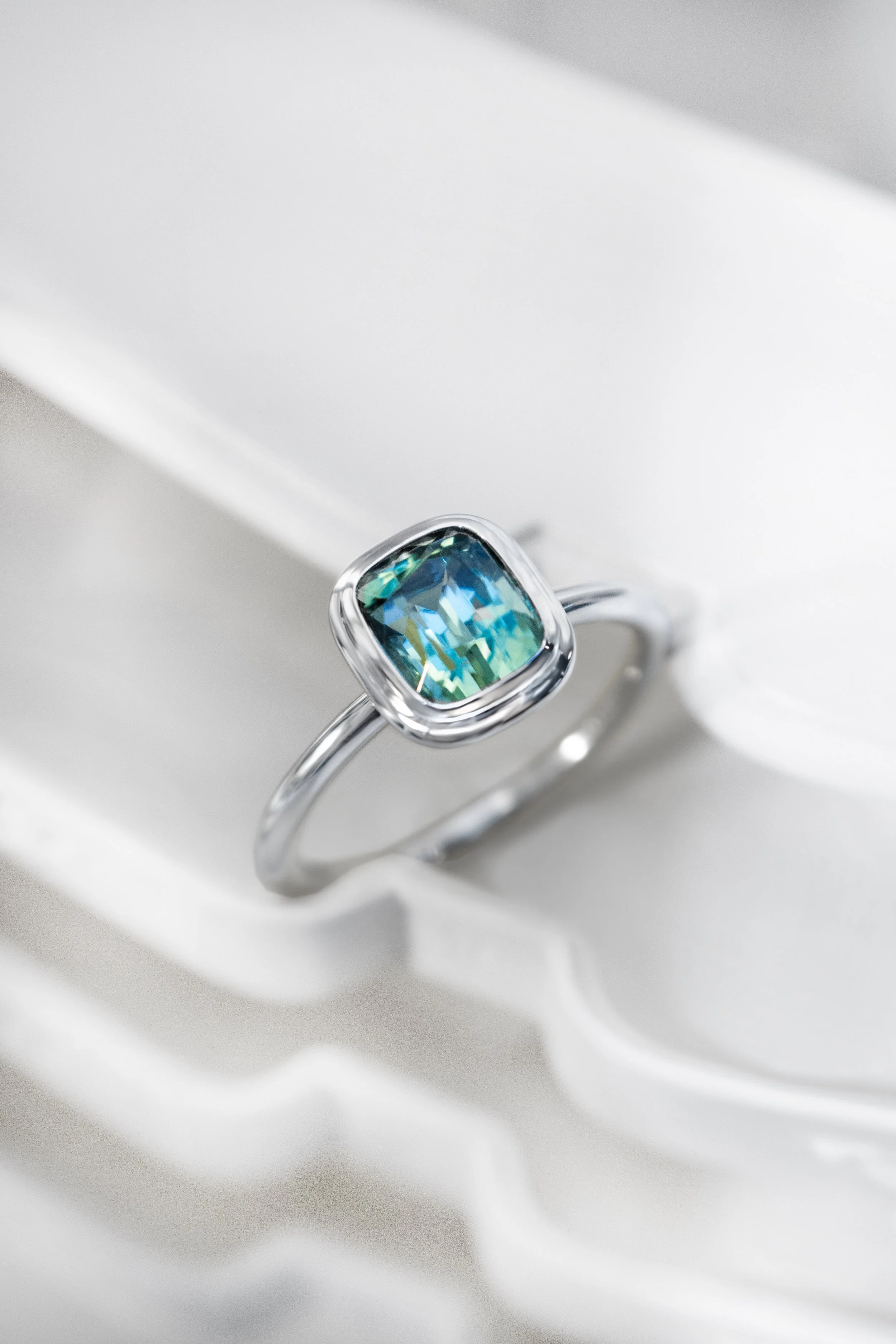 Platinum ring by Sophie Cudworth set with mint tourmaline in double bezel setting 